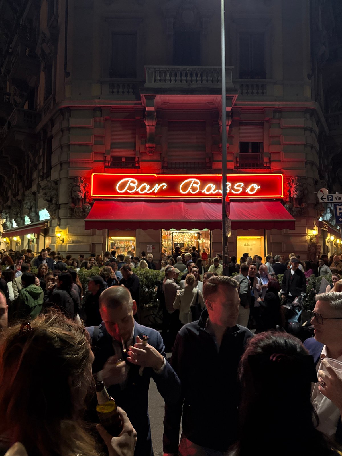 Crowds gather outside Milan's Bar Basso during evening hours