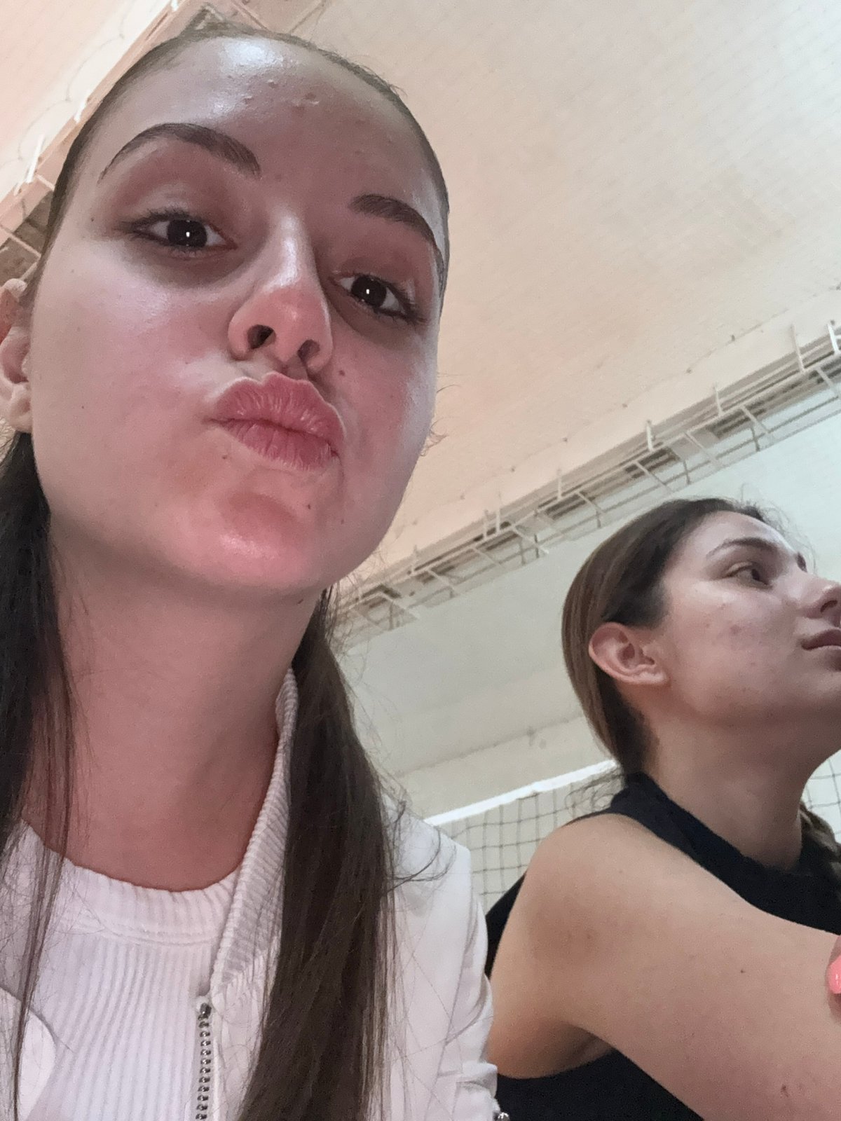Young women photograph casual gathering in Bulgarian sports hall