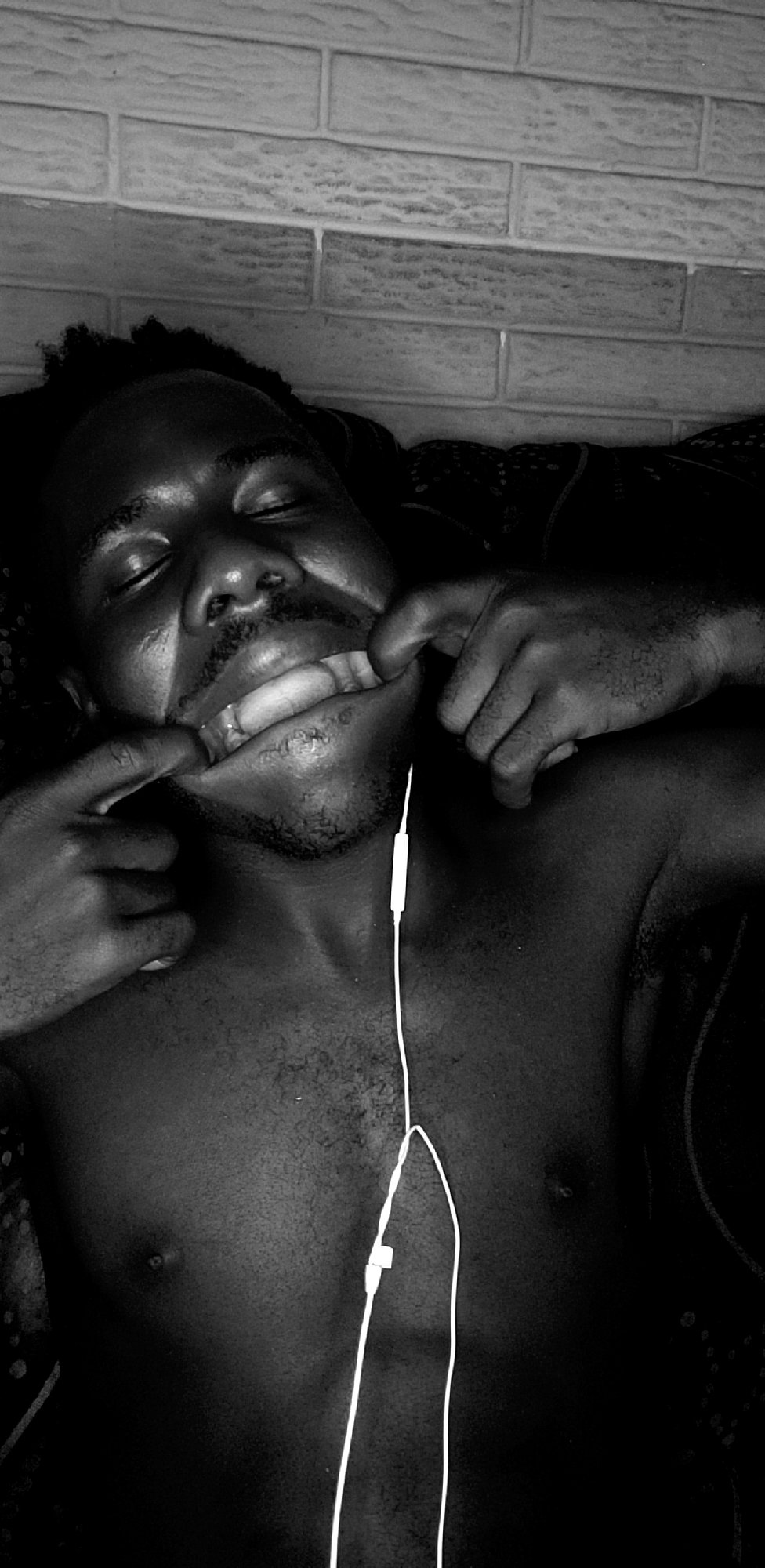 Man photographed lying with headphones in Narayi, Nigeria