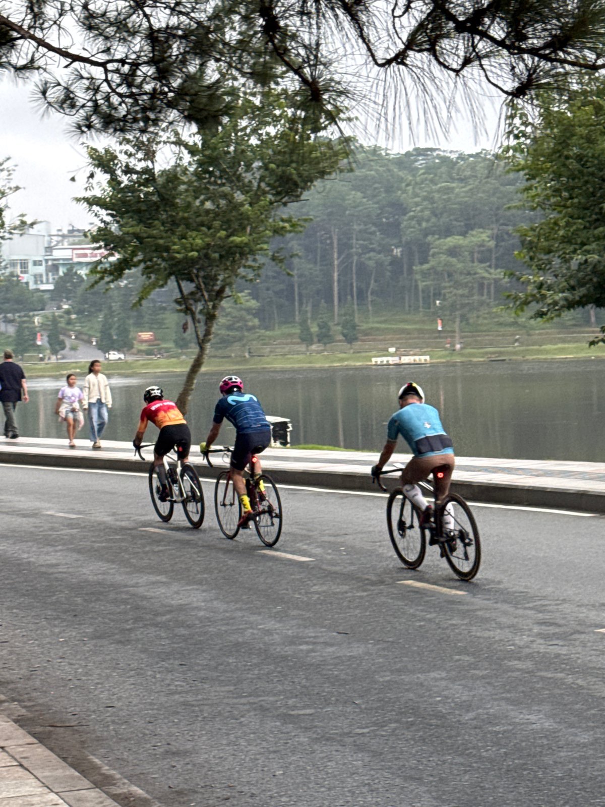Cyclists and joggers circle Xuân Hương Lake at dusk