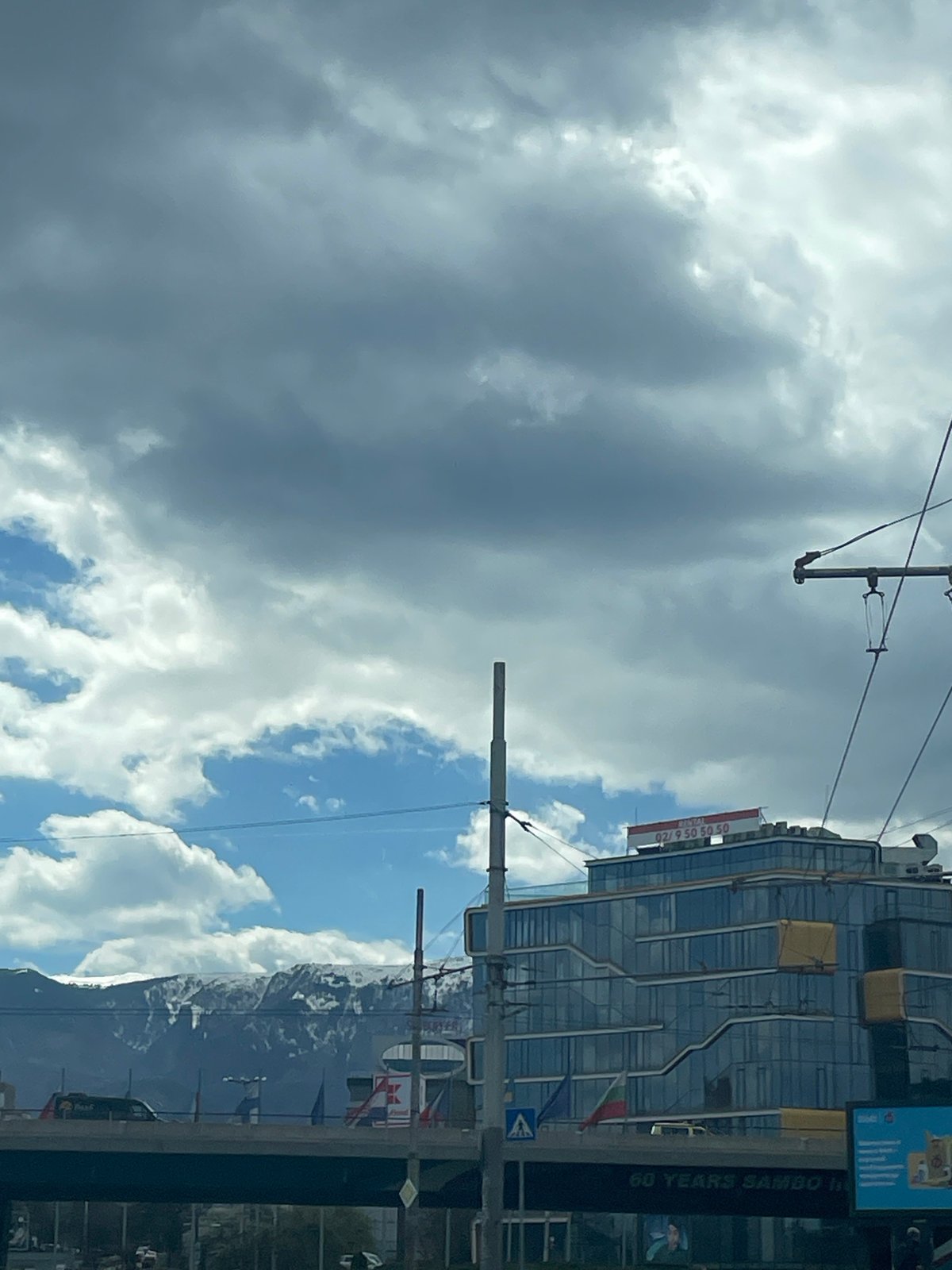 Modern building with phone signage observed in Sofia street scene