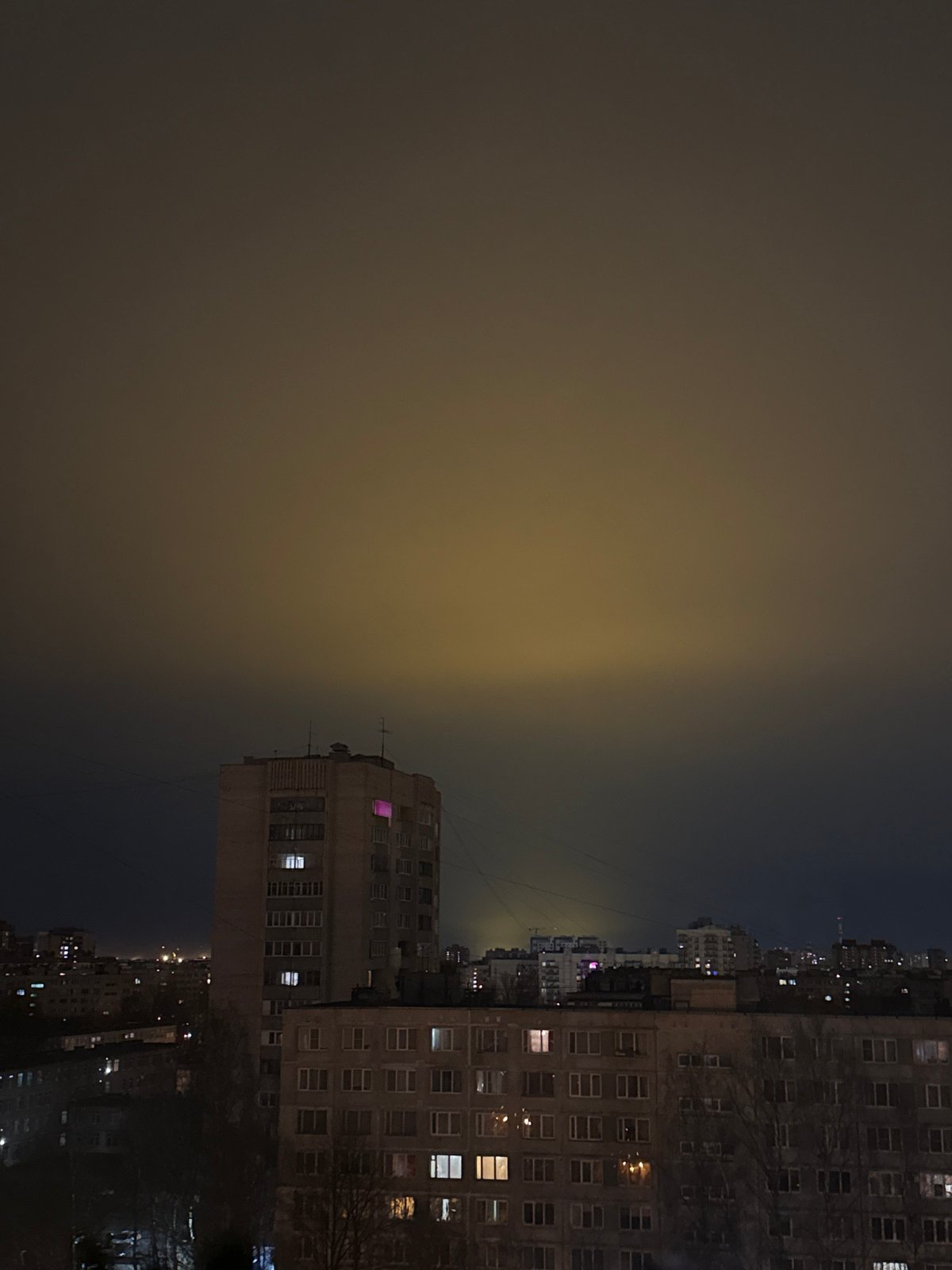 Dense fog blankets Saint Petersburg under overcast night sky