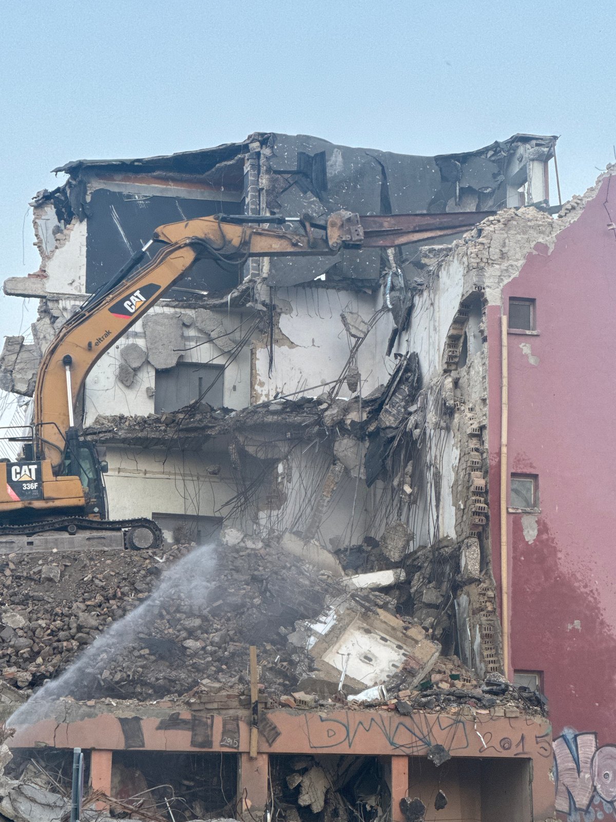 CAT excavator demolishes collapsed building in Varna