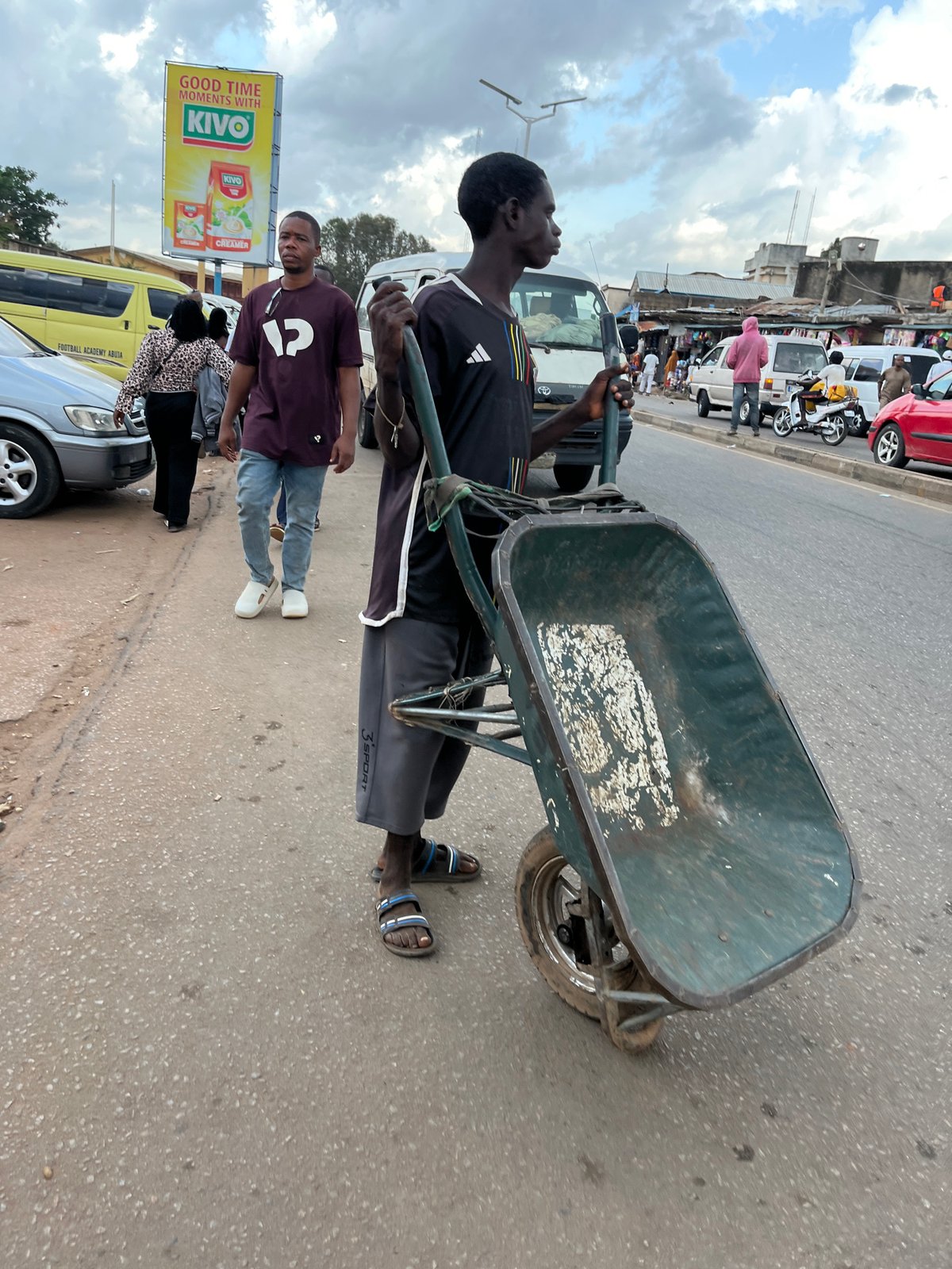 Street life on a Jos, Nigeria road on a cloudy afternoon