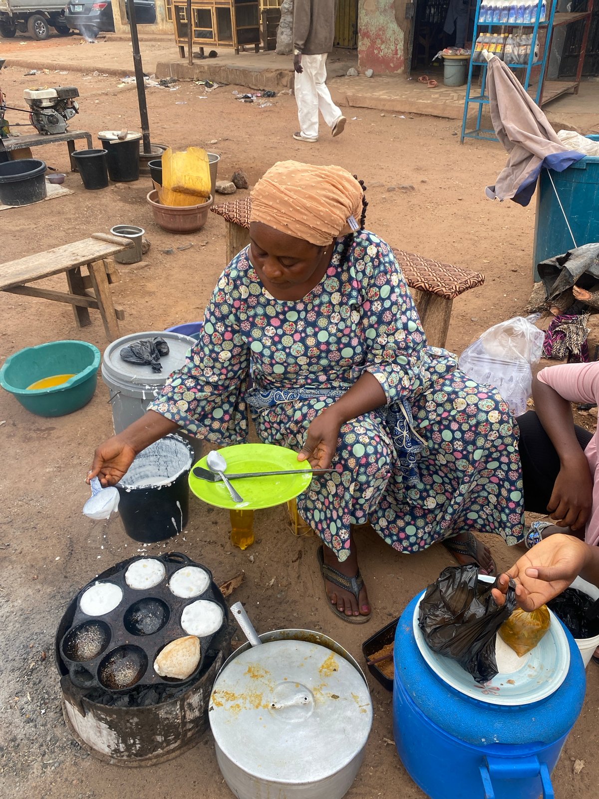 Woman prepares food outdoors in Rido, Nigeria