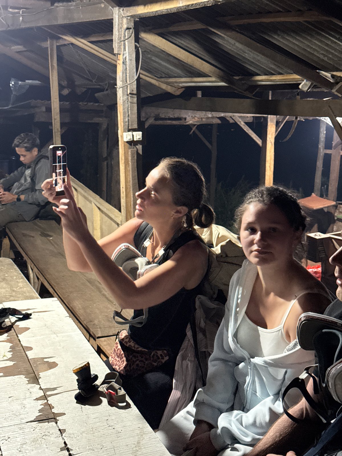 Evening gathering at Indonesian roadside kiosk draws small crowd