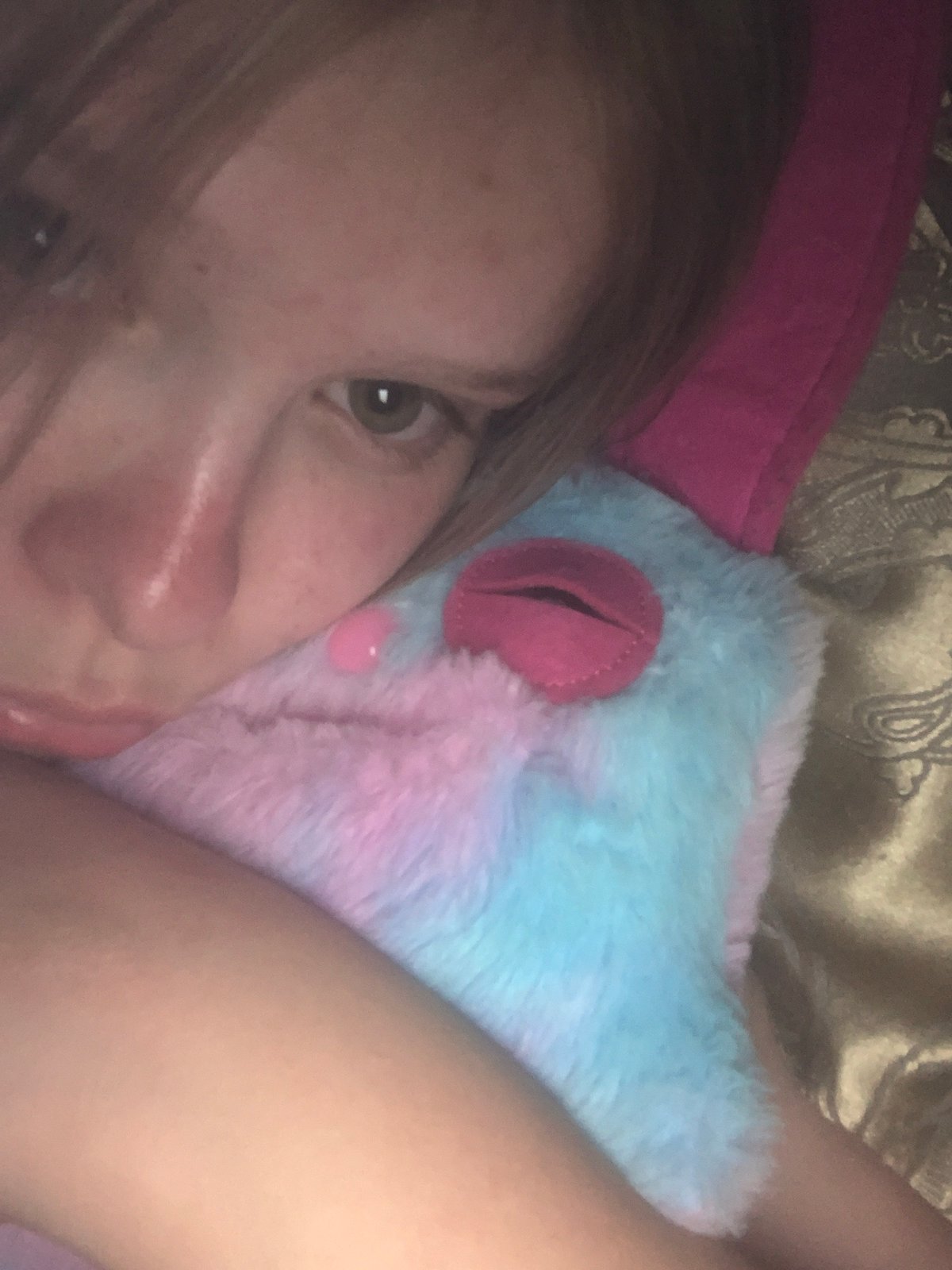 Young person documents evening selfie session with stuffed animal