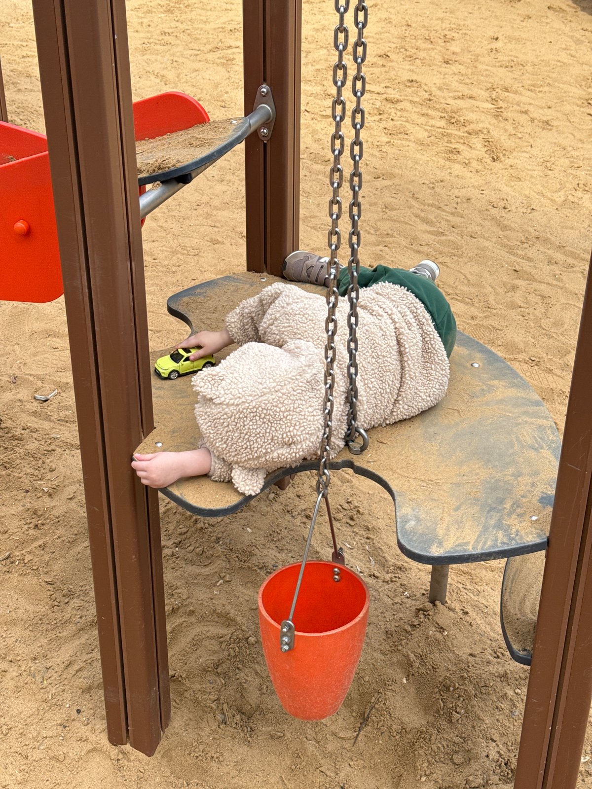 Child plays at Moscow playground amid spring blooms