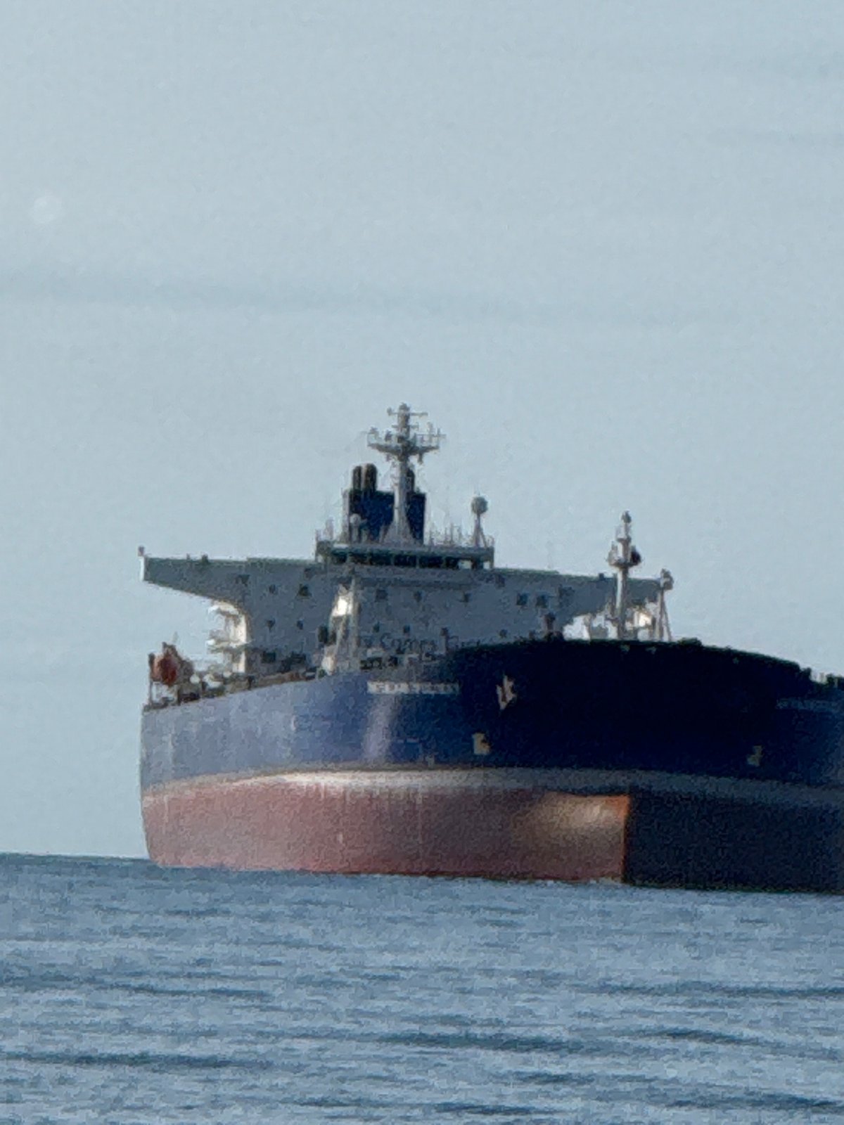 Fishing off Teriberka with a cargo ship passing nearby