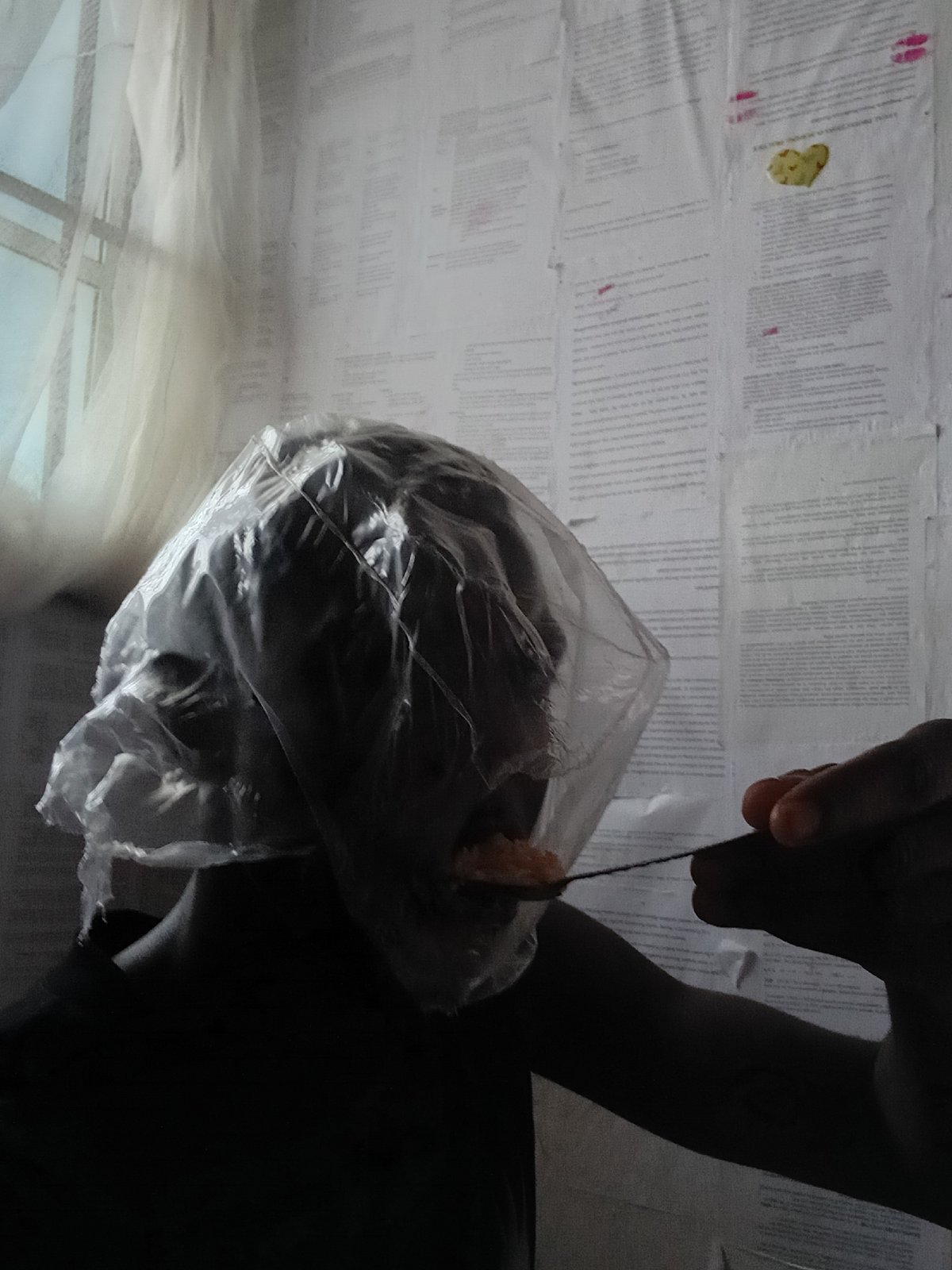 Person eating meal on floor in Akwete, Nigeria