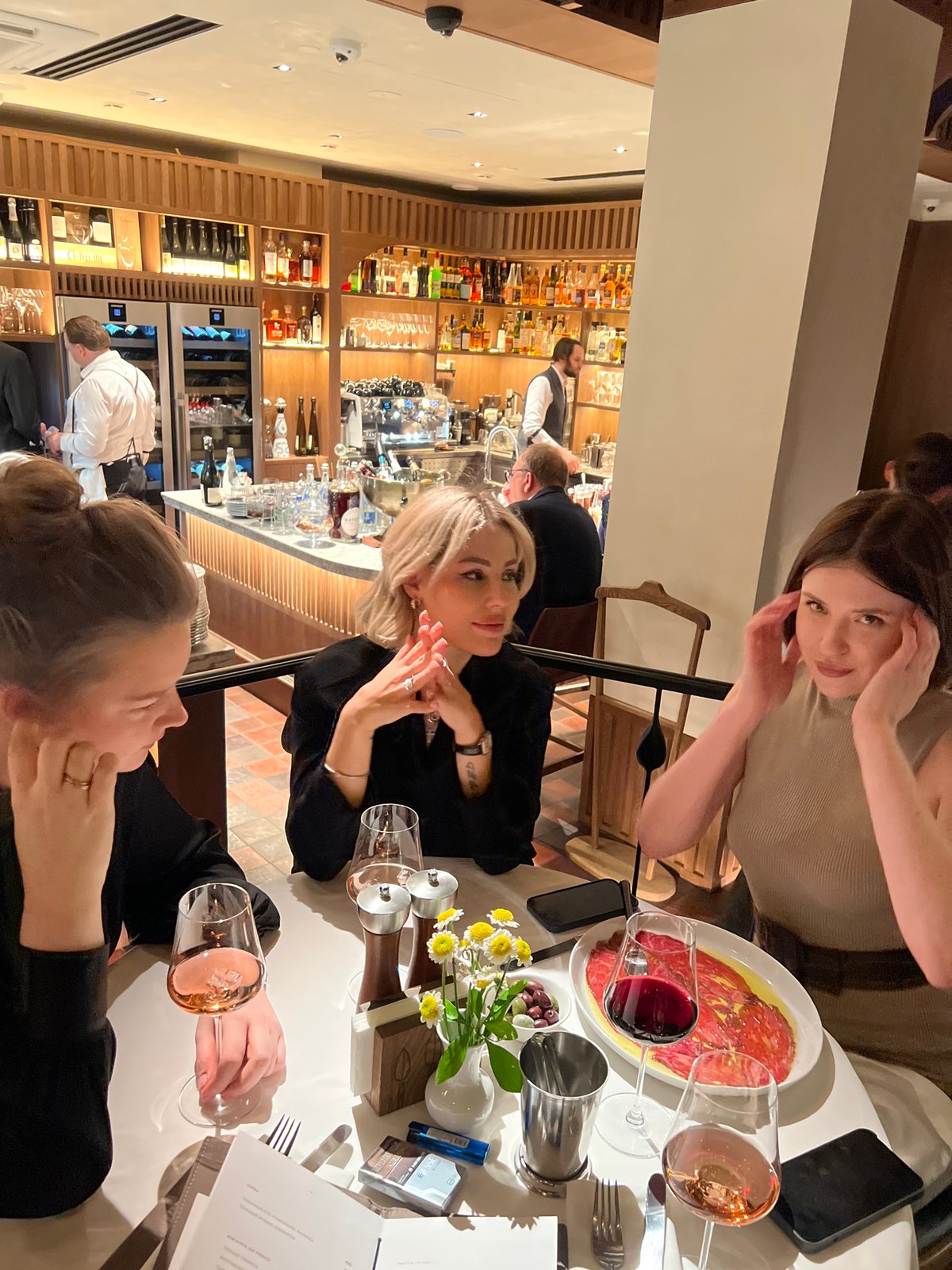 Women dine at upscale restaurant during evening hours