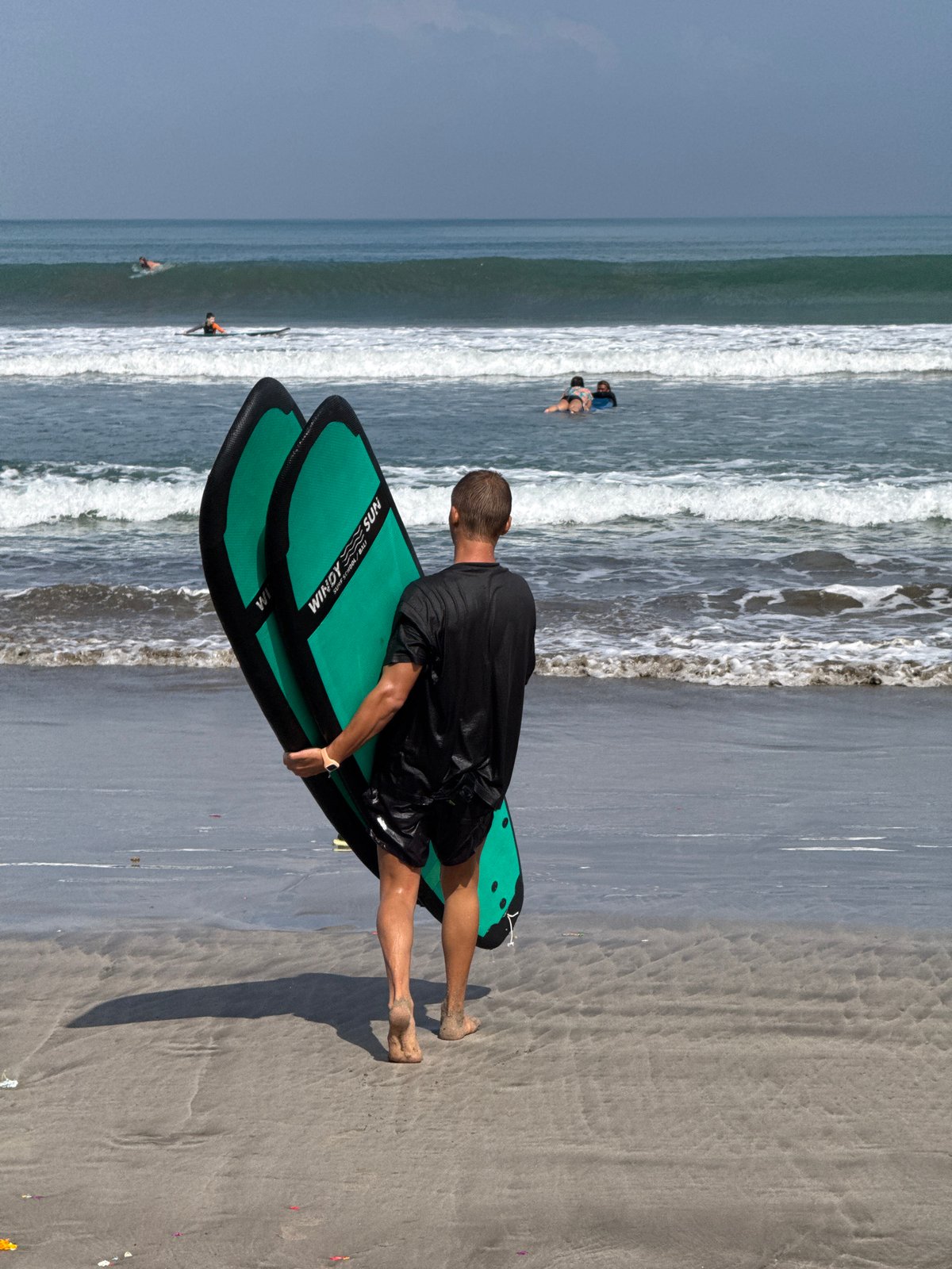 Early morning surf gathering at Kuta Beach, Indonesia