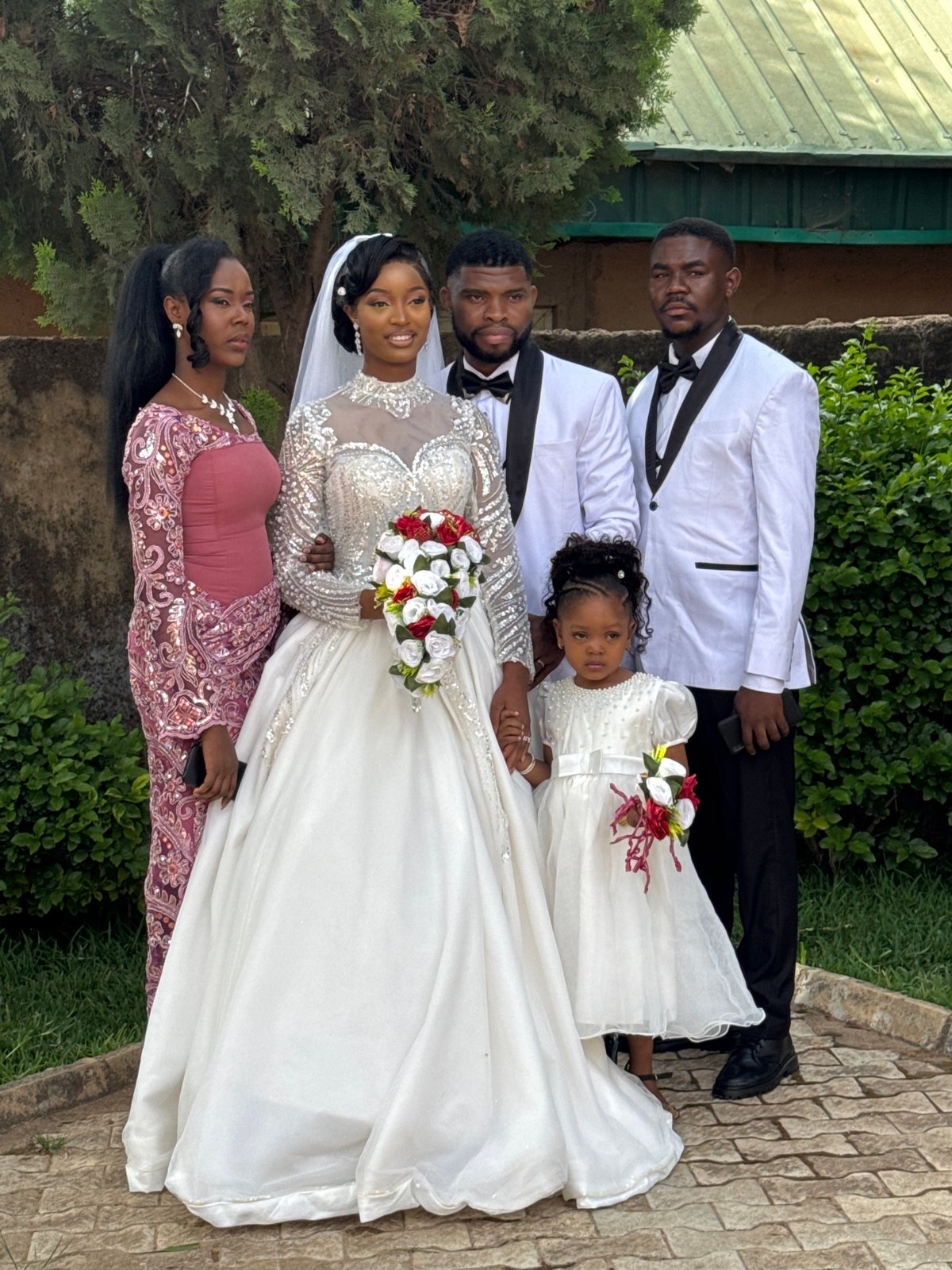 Wedding party poses for outdoor photographs in Jos, Nigeria