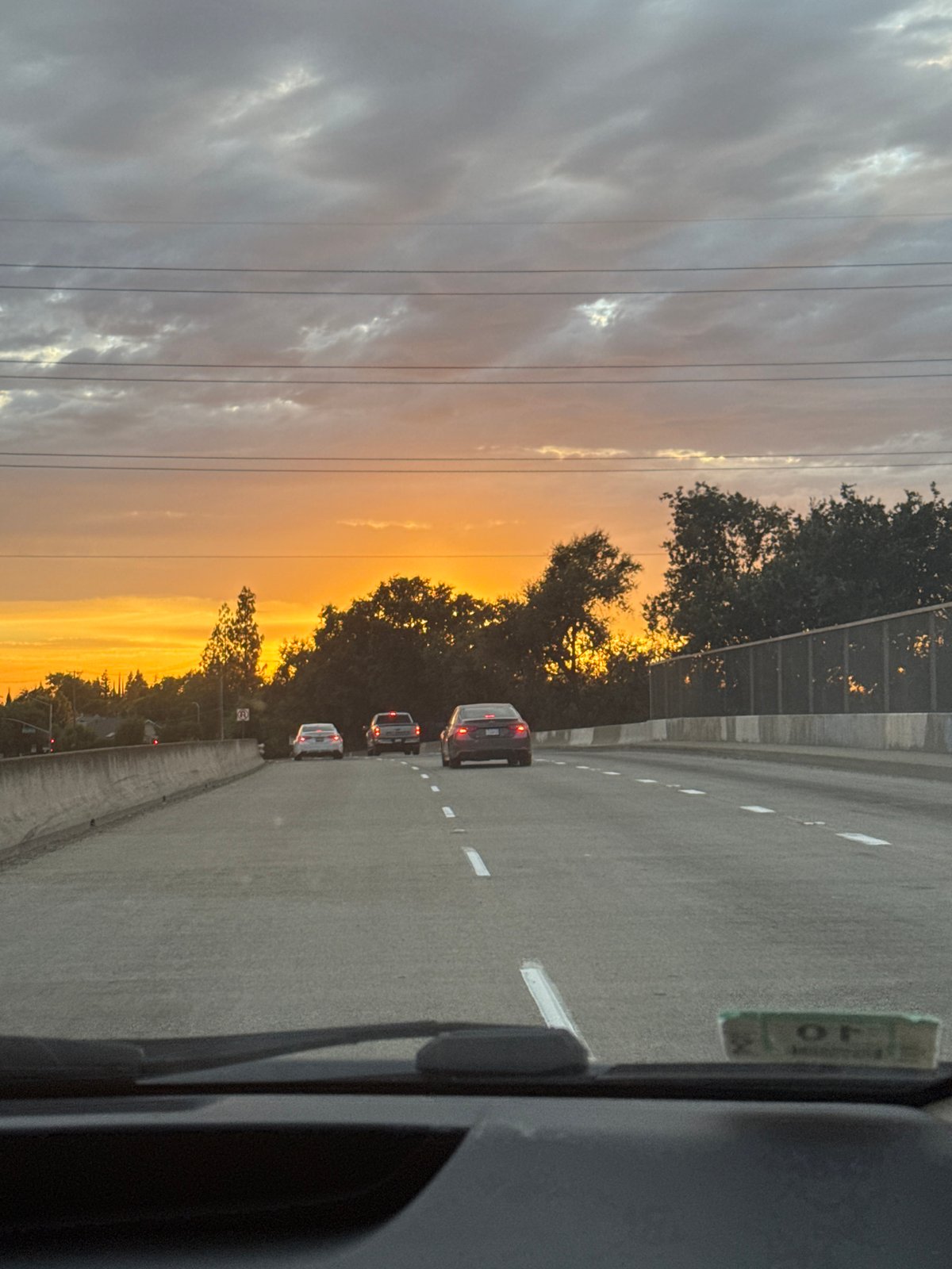 Highway drive through Foothill Farms under a vivid sunset sky