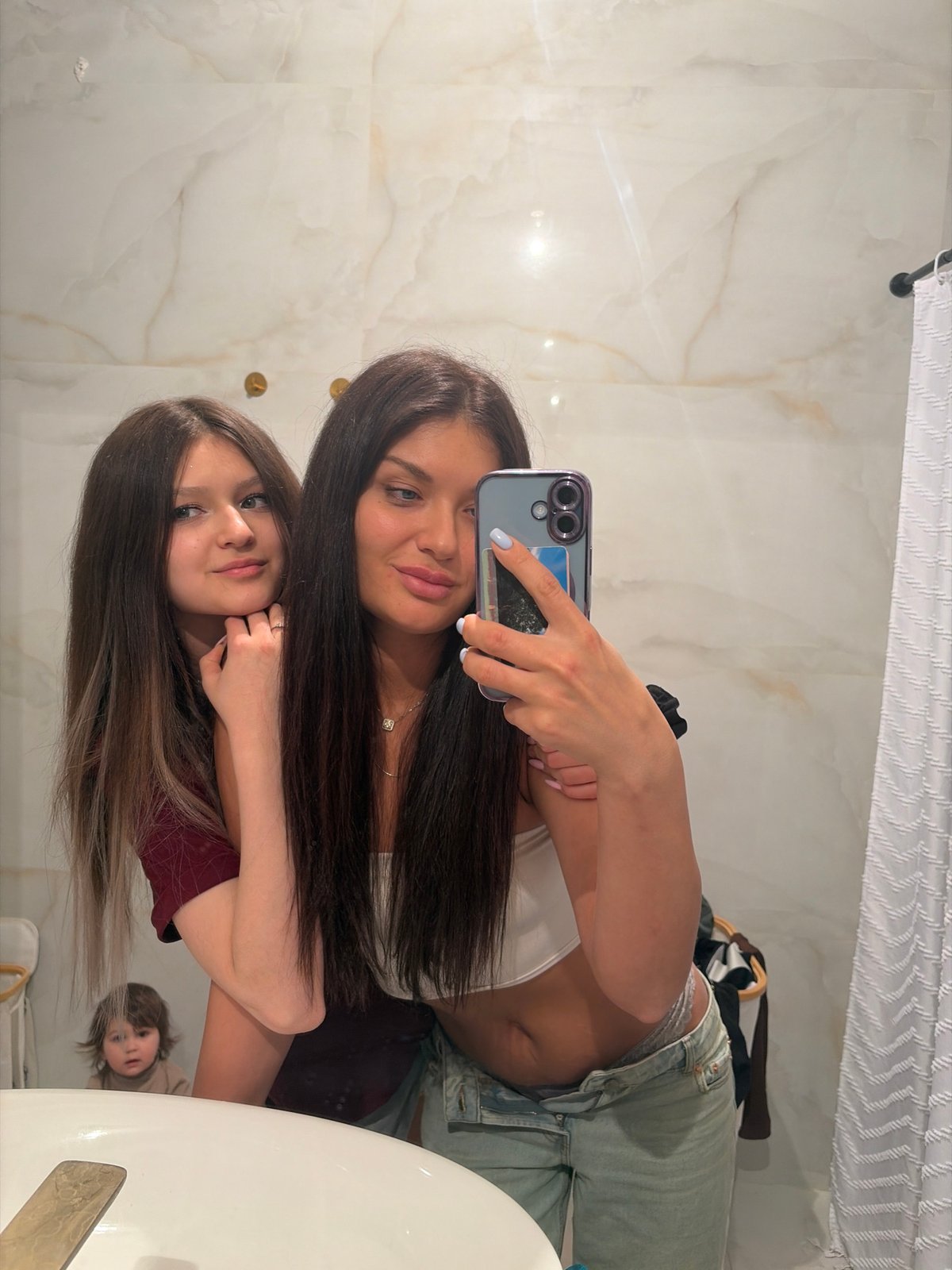 Two women take bathroom selfies in Moscow