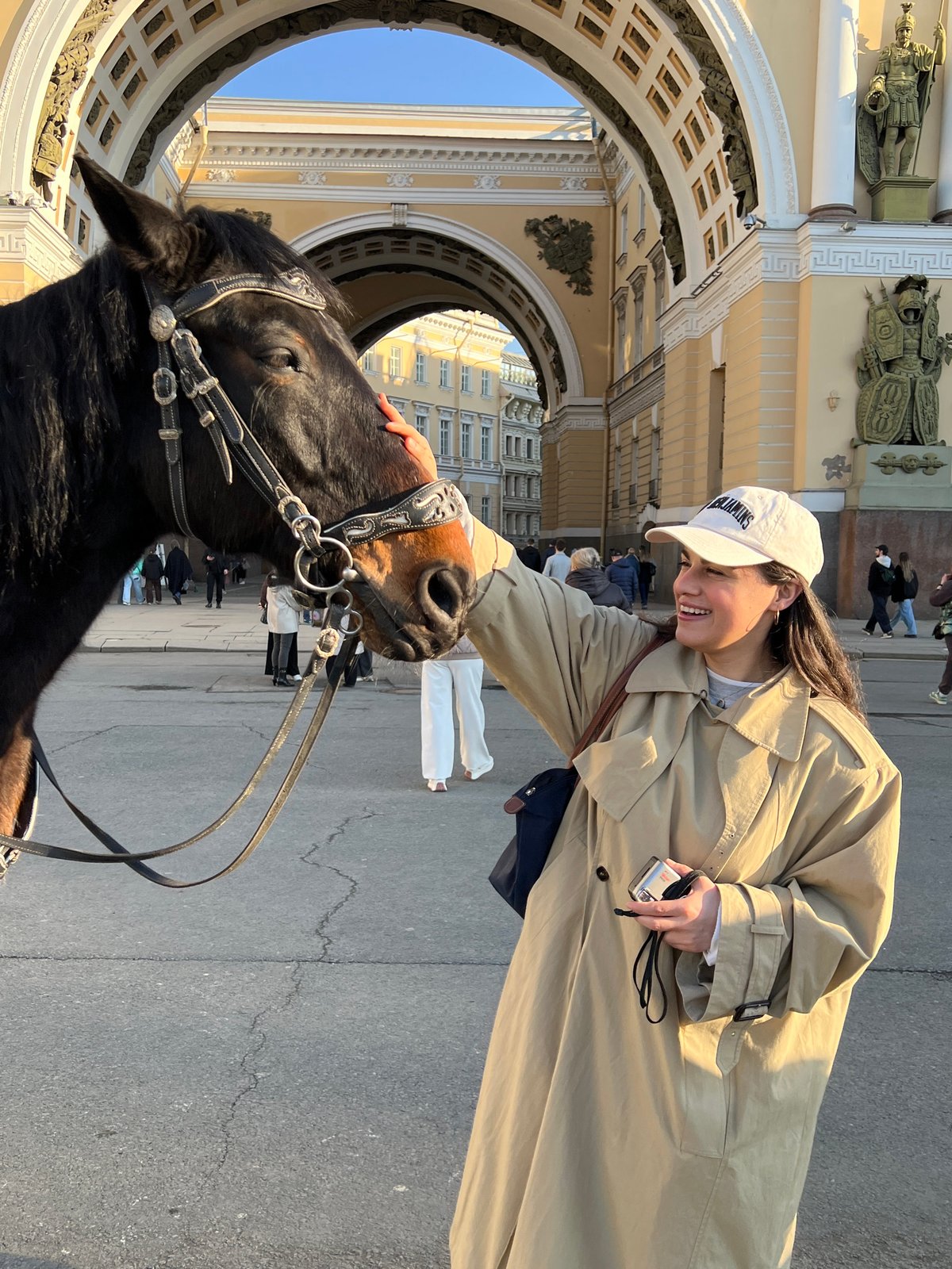 Woman pets horse on Saint Petersburg street