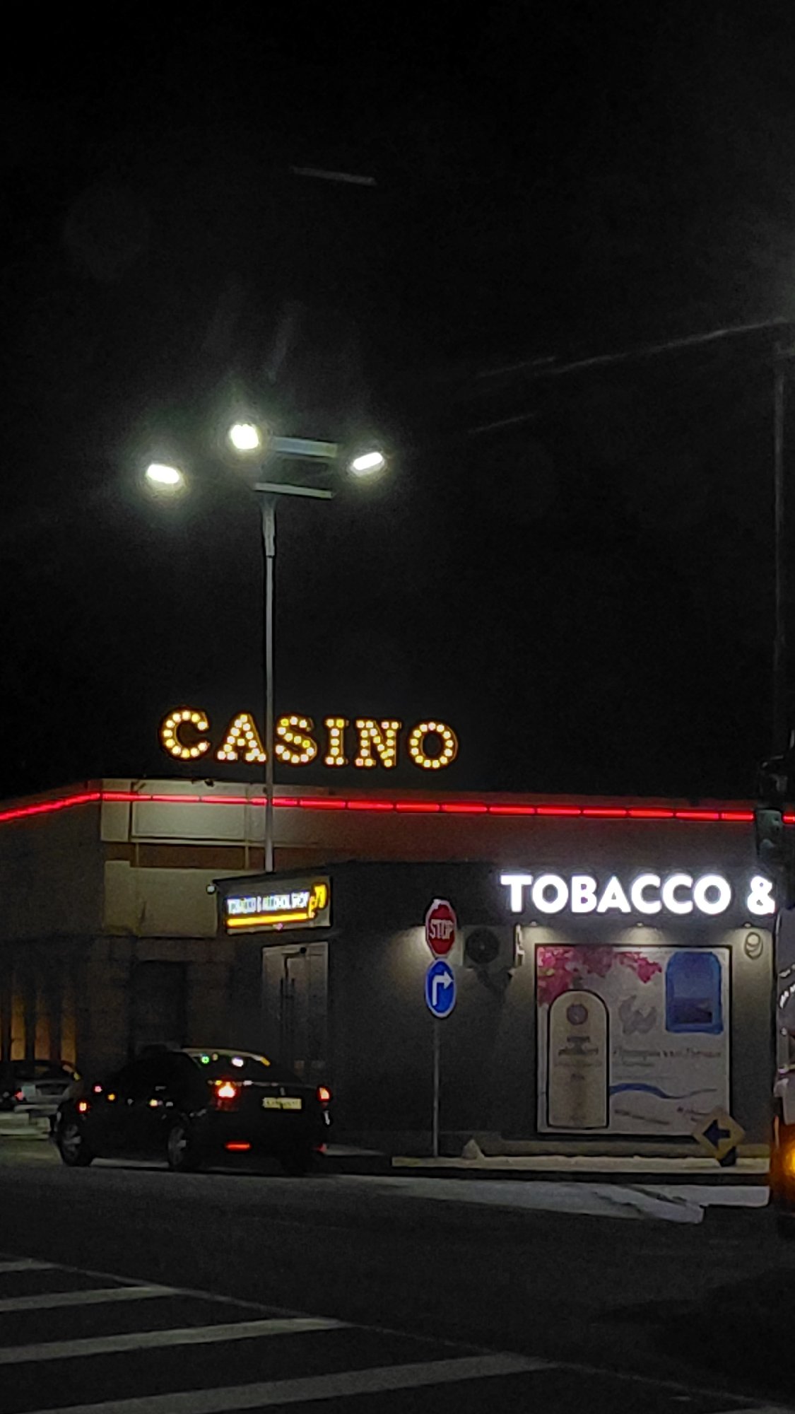 Nighttime casino and tobacco store signs documented by witness