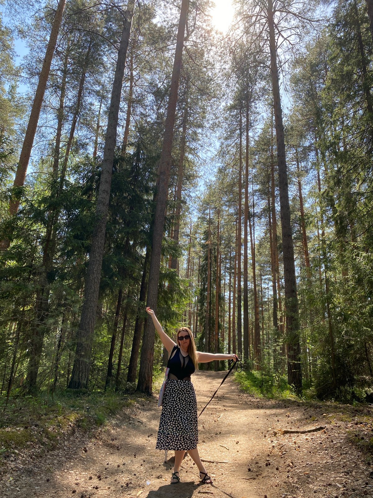 Woman takes morning forest walk with dog in Noviy