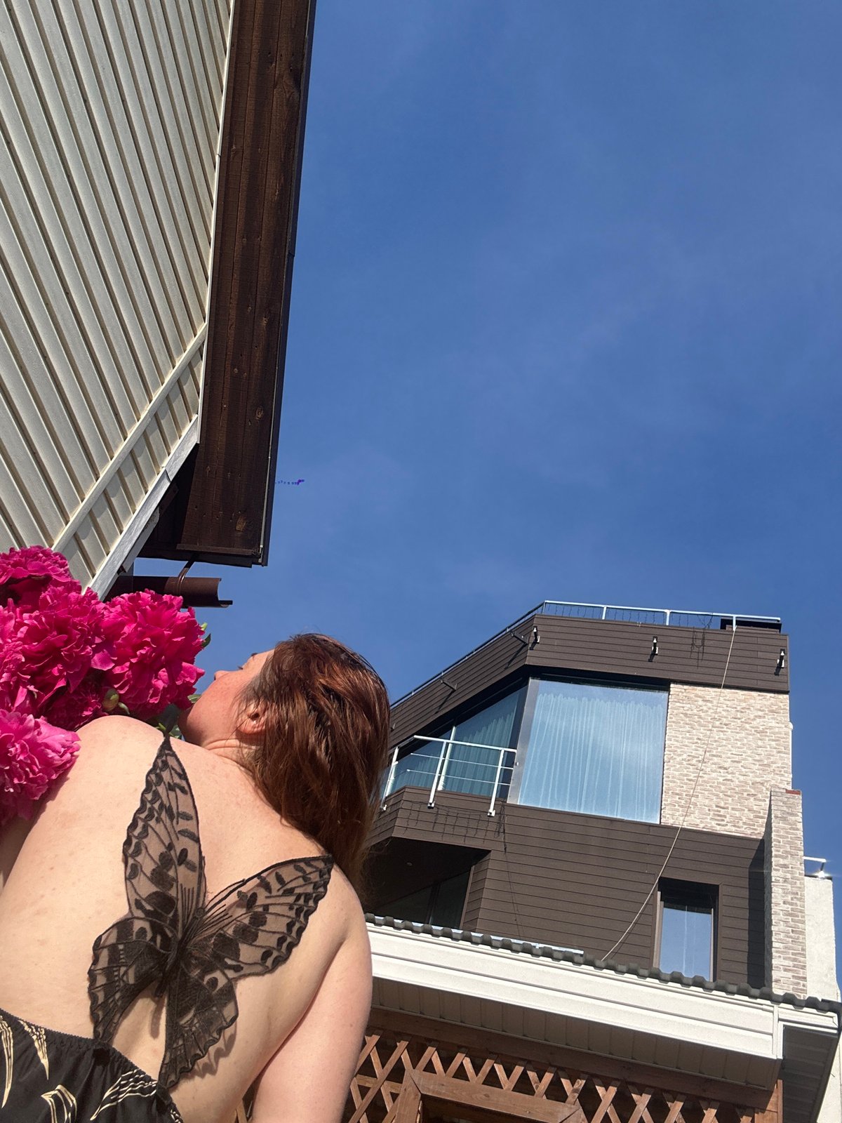 Mother and toddler share peony flowers in Nizhny Novgorod