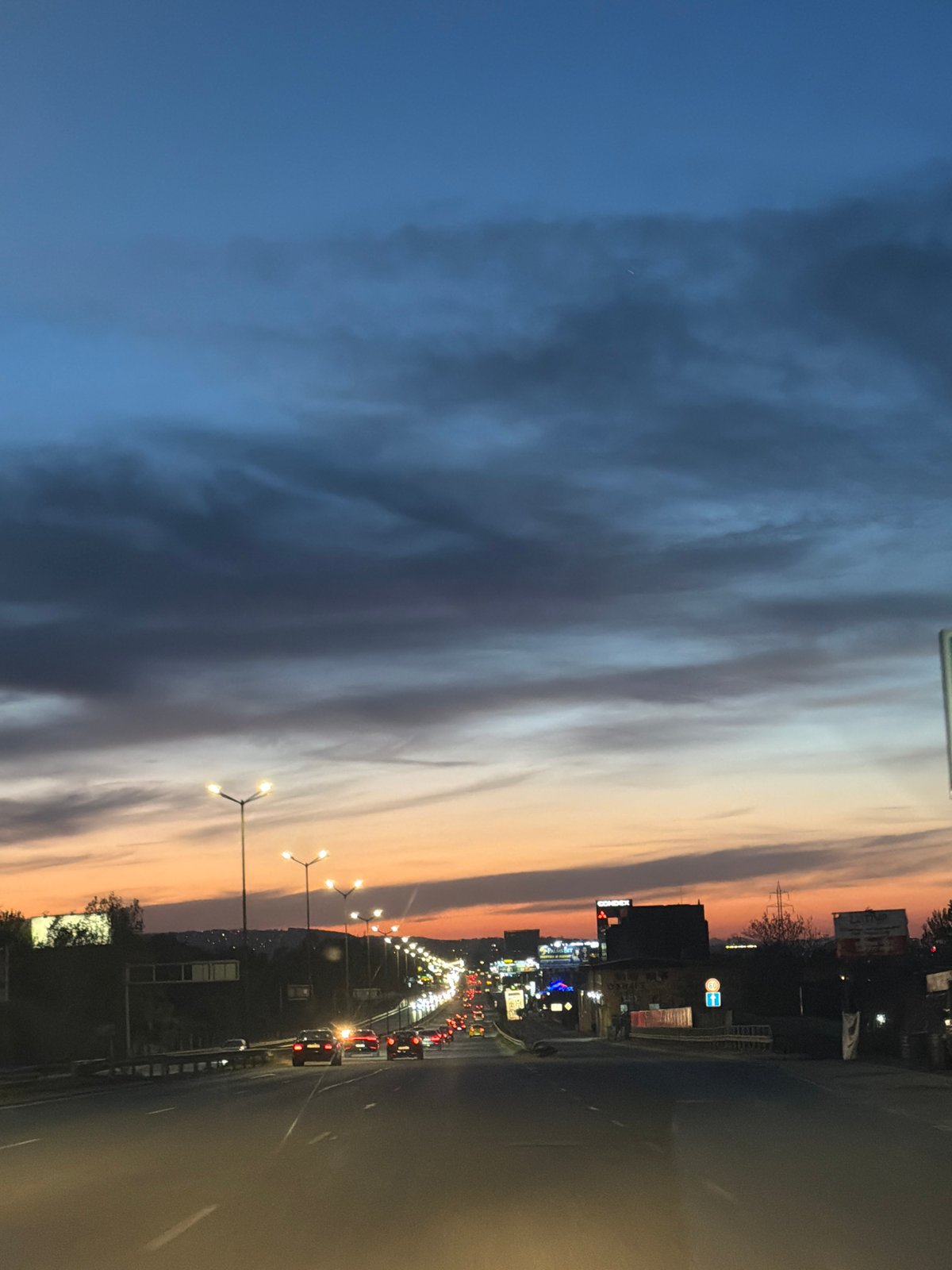 Evening traffic flows through Sofia streets at twilight