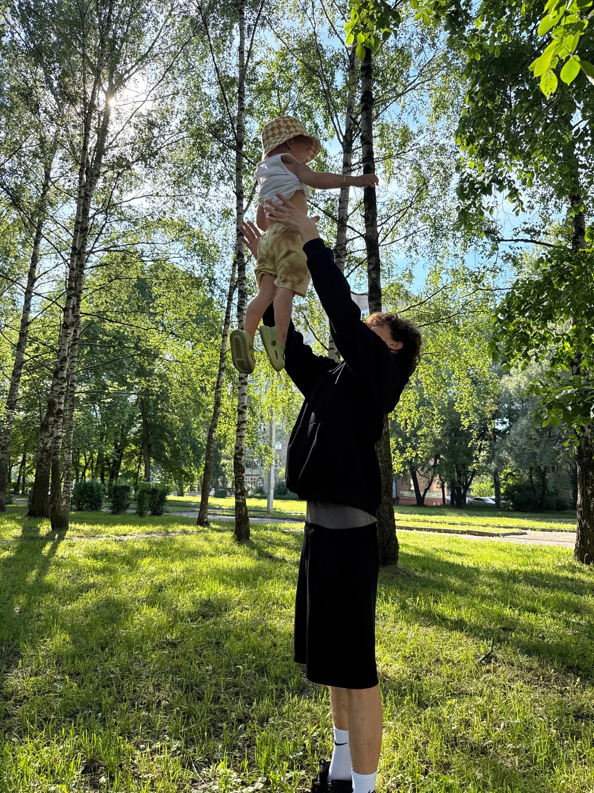 Family enjoys afternoon park outing with toddler and selfies