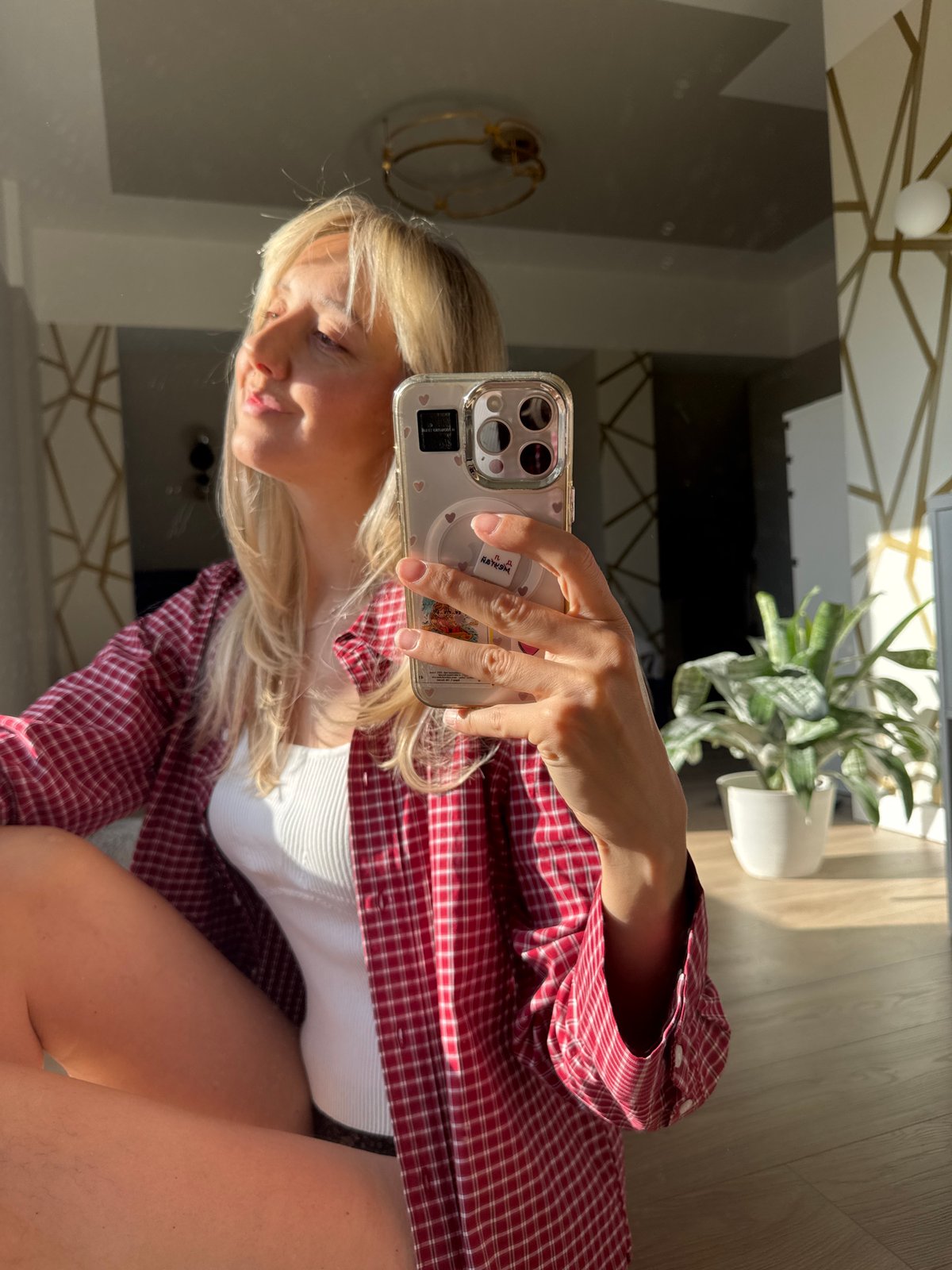 Woman takes morning selfies in Carnikava, Latvia apartment