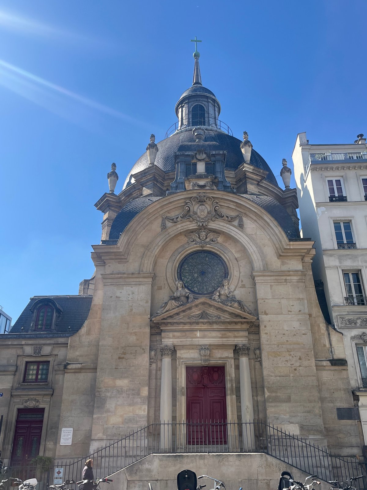 Historic domed building photographed under clear skies in Paris