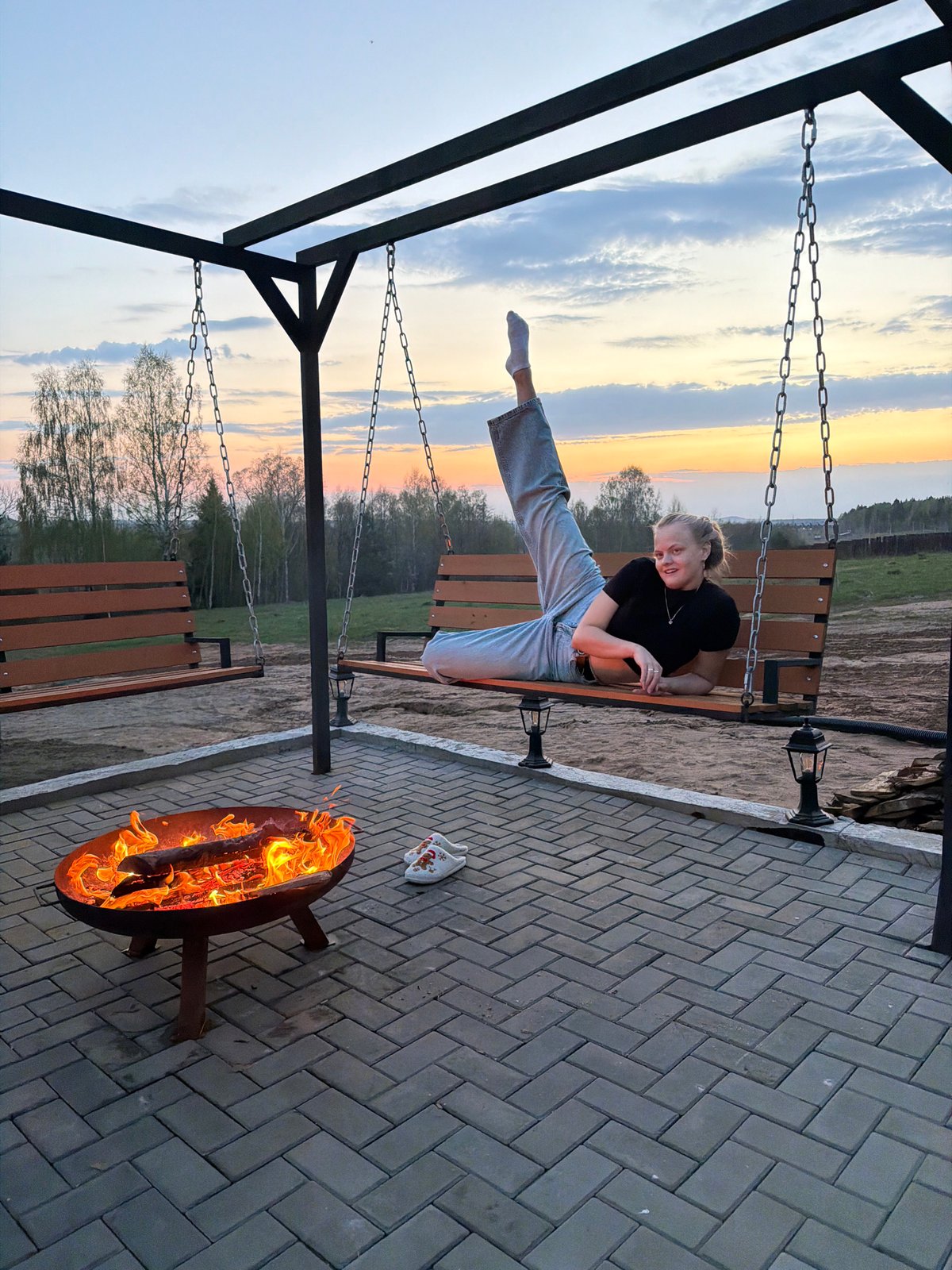 Woman enjoys evening fire pit gathering in Kamennoye, Russia