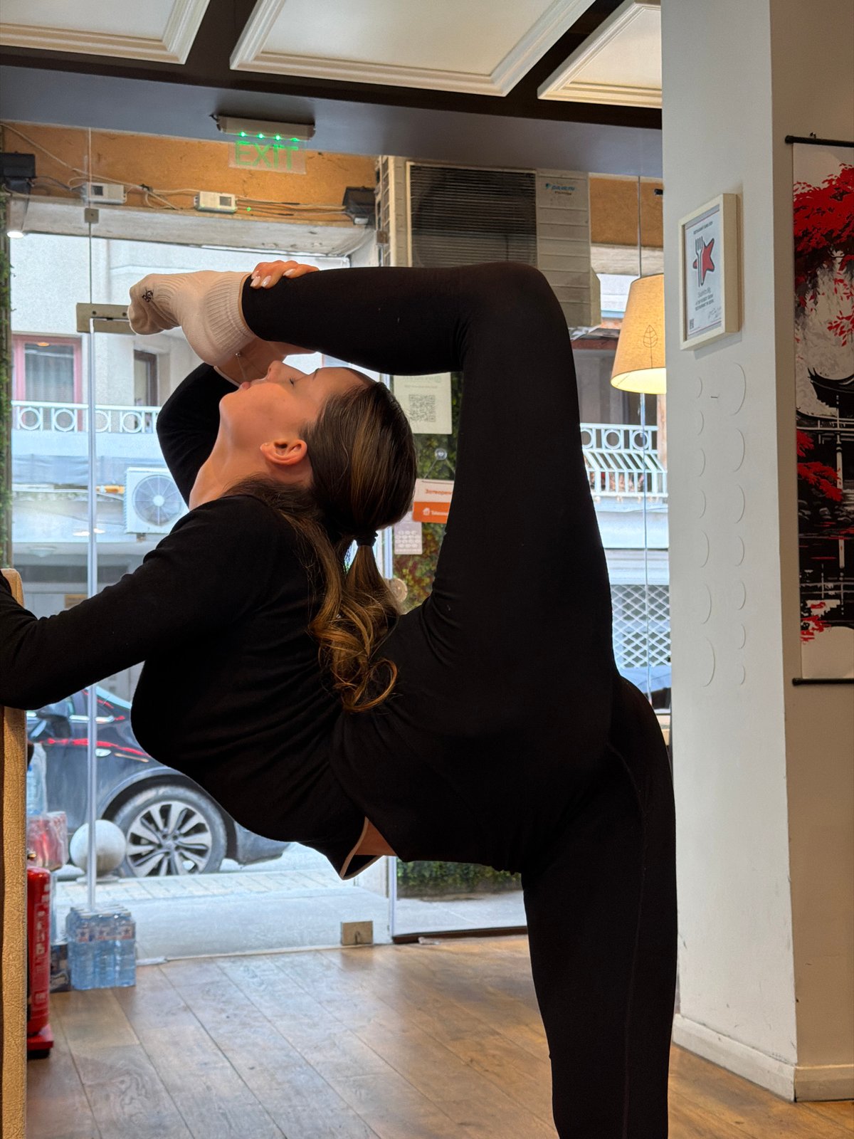 Woman performs yoga routine in Sofia cafe