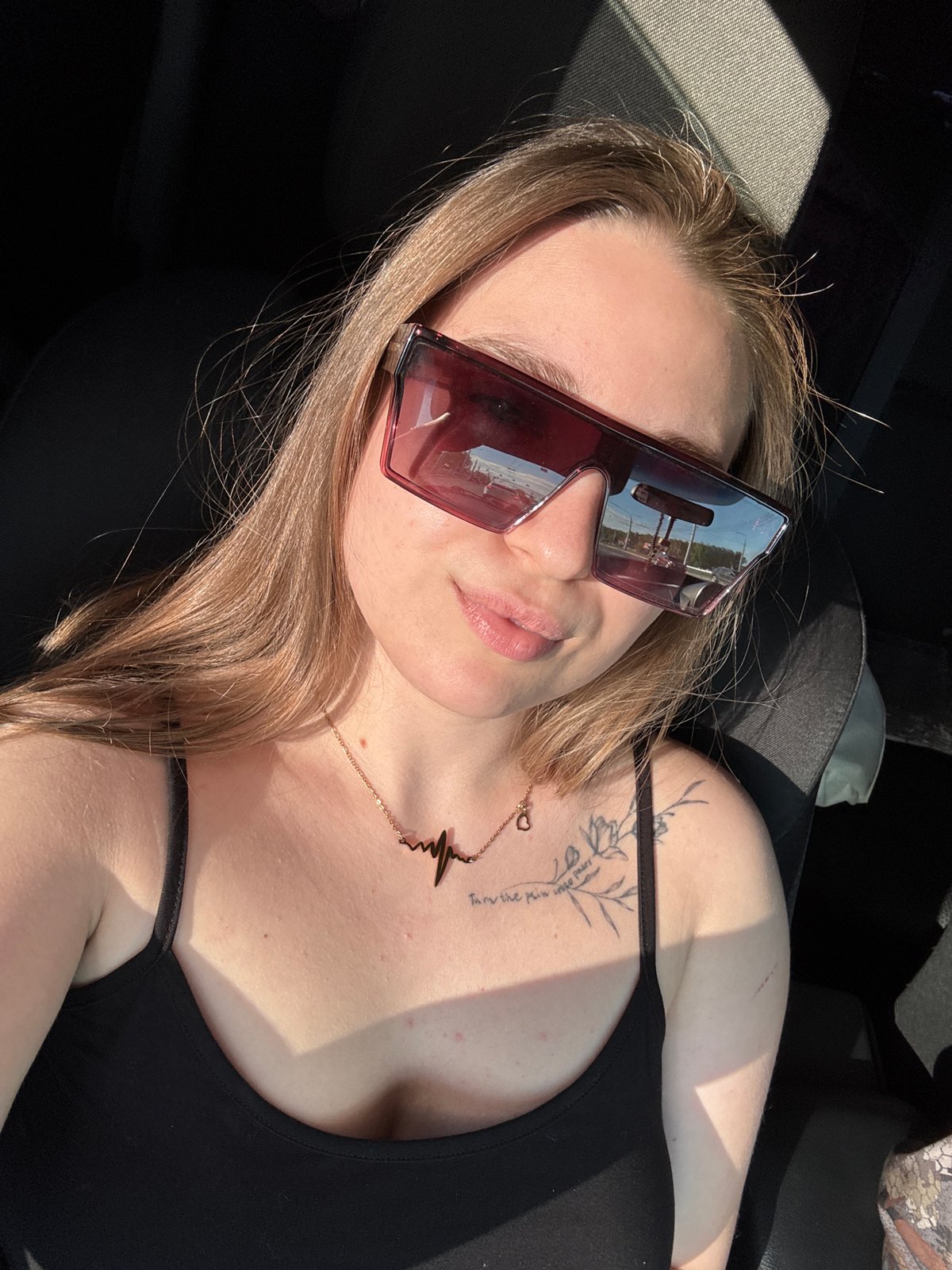 Person photographed in car wearing sunglasses in Omsk