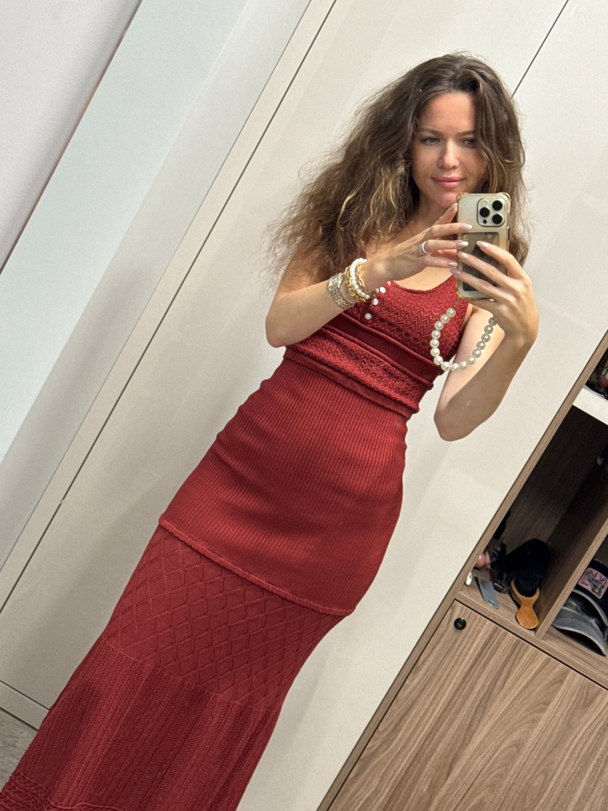 Red knit dress mirror selfies in a minimalist dressing space
