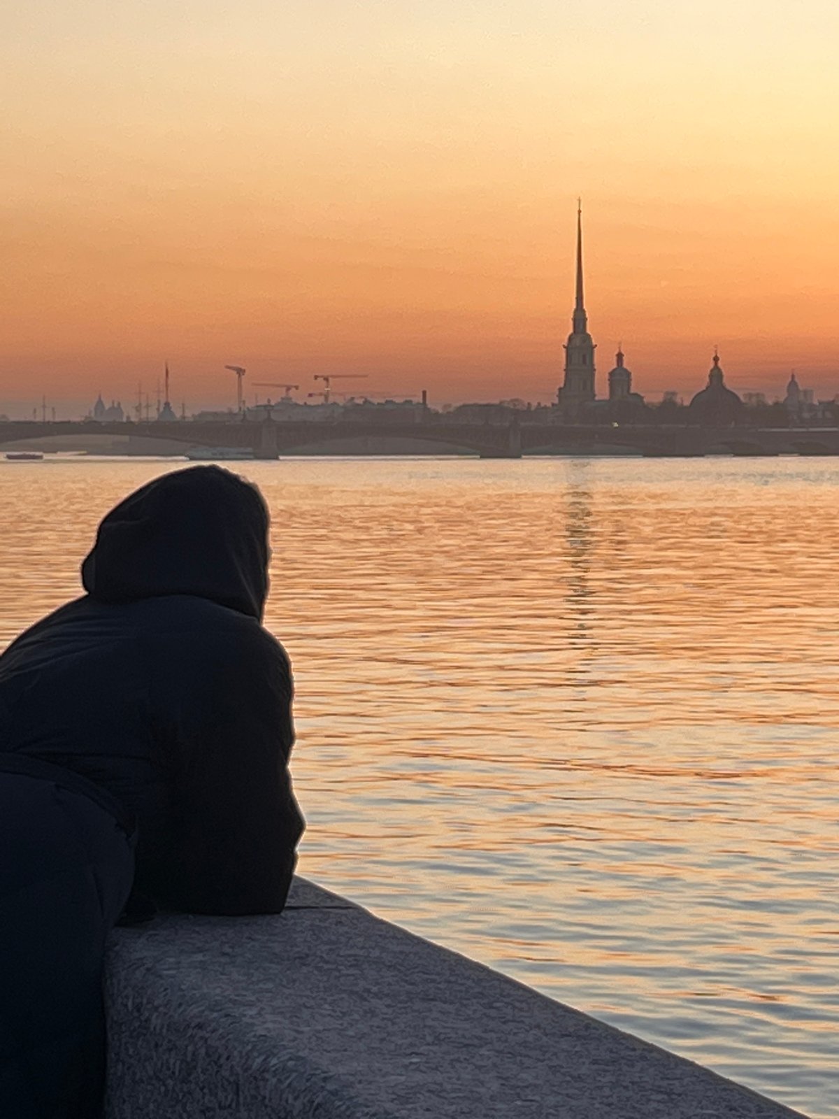 Evening waterfront activities captured along Saint Petersburg's Neva River
