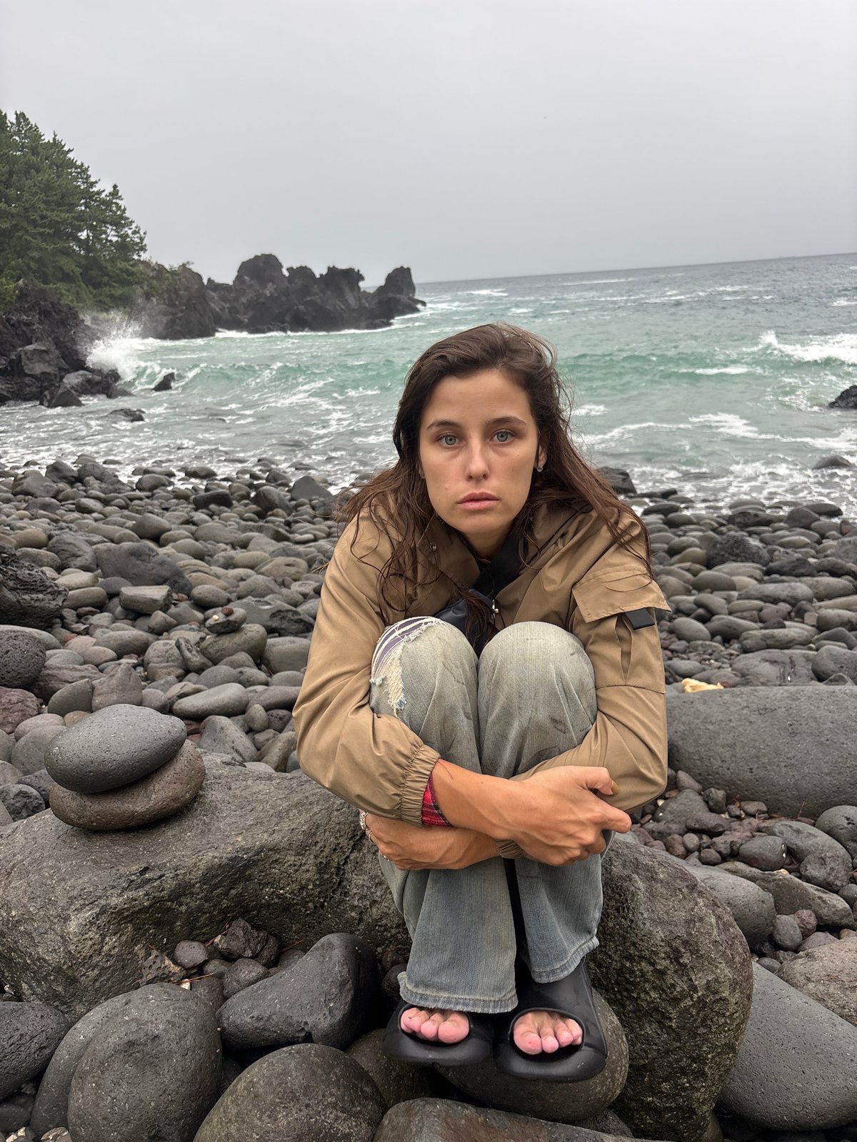 Hanging out on Jeju's rugged volcanic coastline on an overcast morning