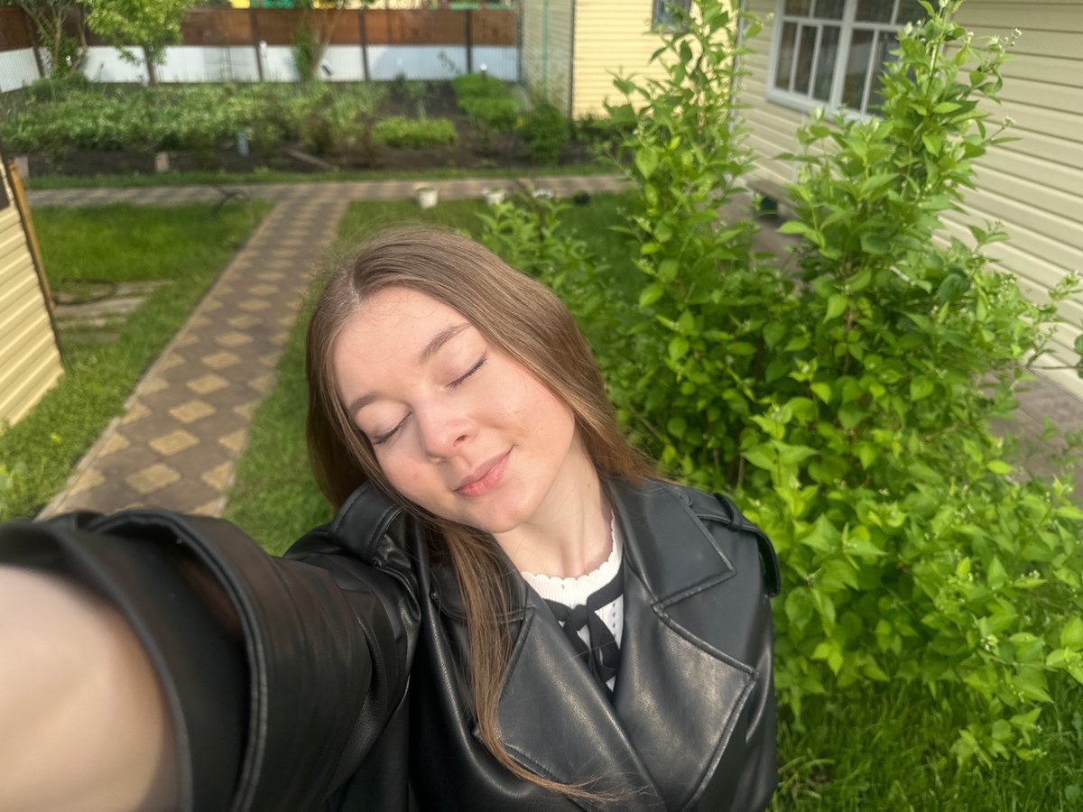 Woman photographs herself in residential Коноваловка, Russia