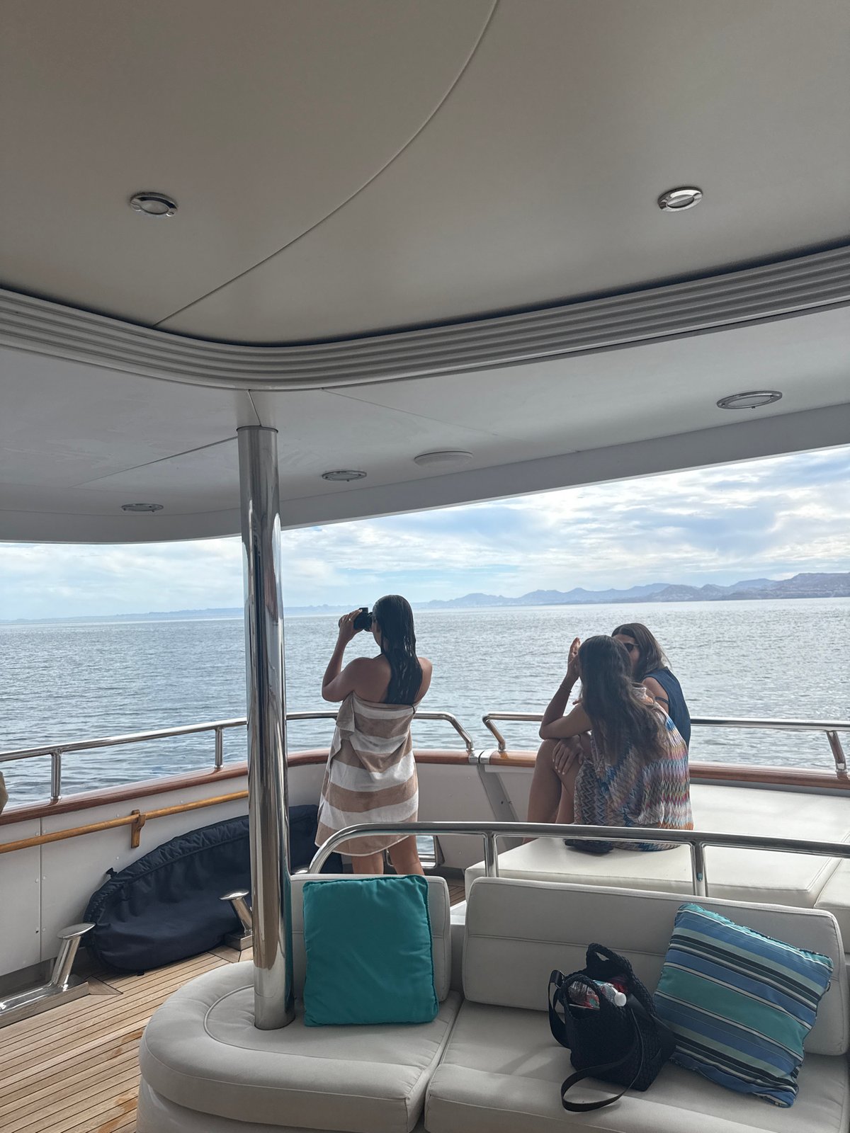 Yacht passengers cruise Mexican coast during evening hours