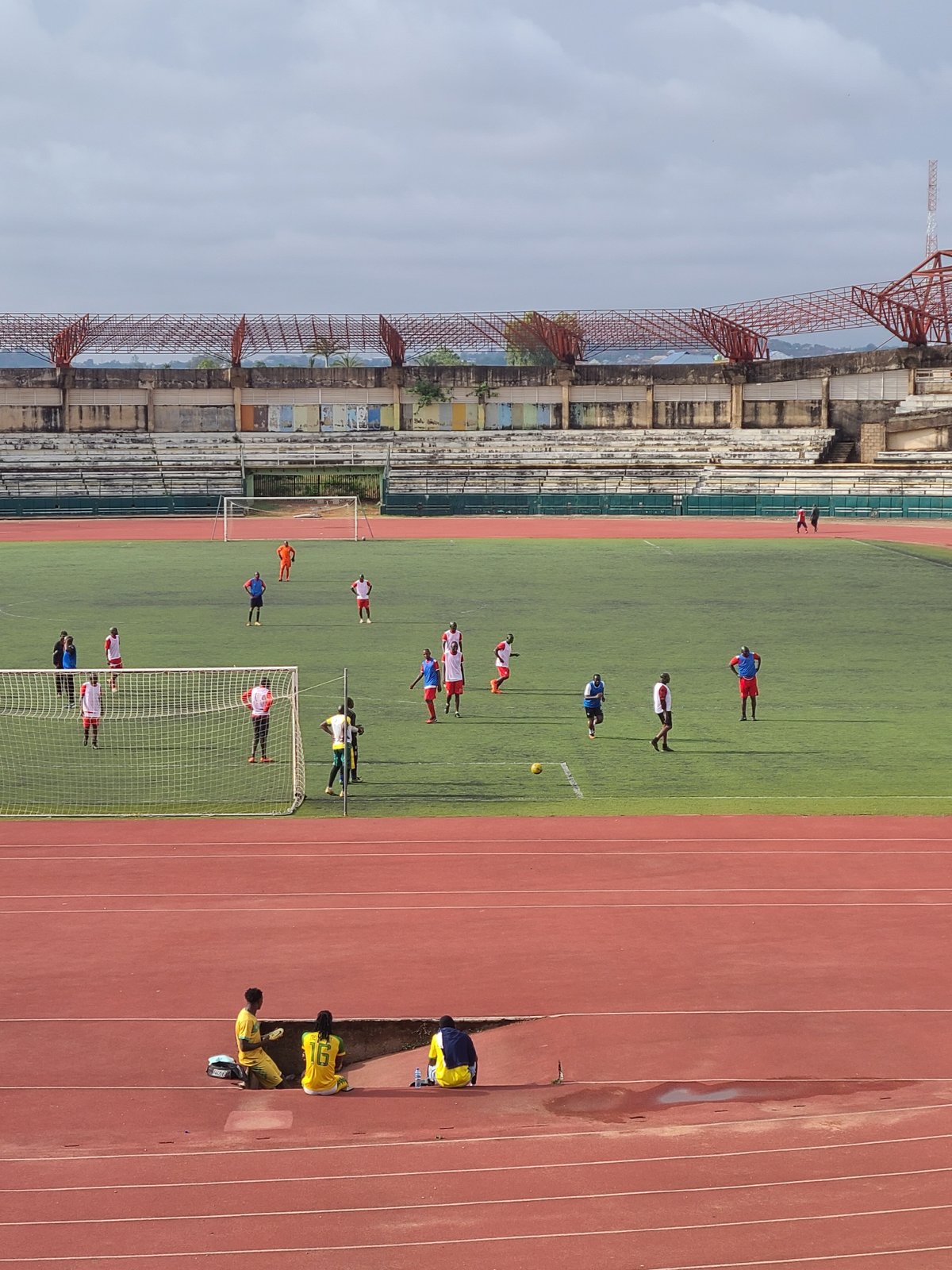 Athletes practice at weathered stadium facility during morning hours