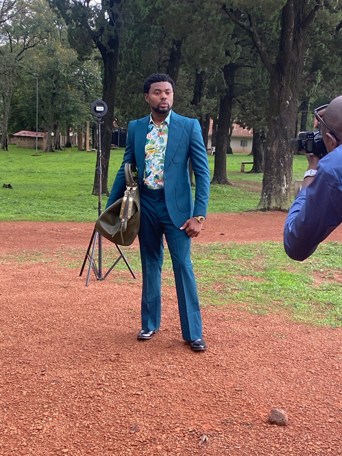 Teal suit photoshoot on a gravel path in Jos
