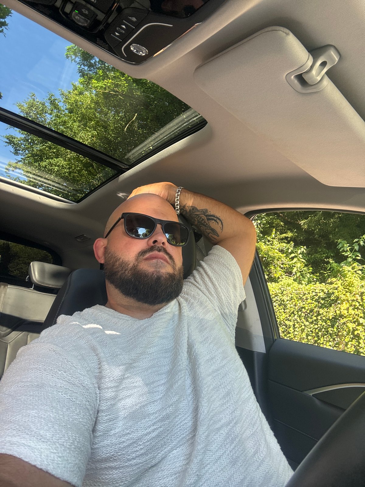 Chilling in a car with sunroof open, Sochi summer sky above