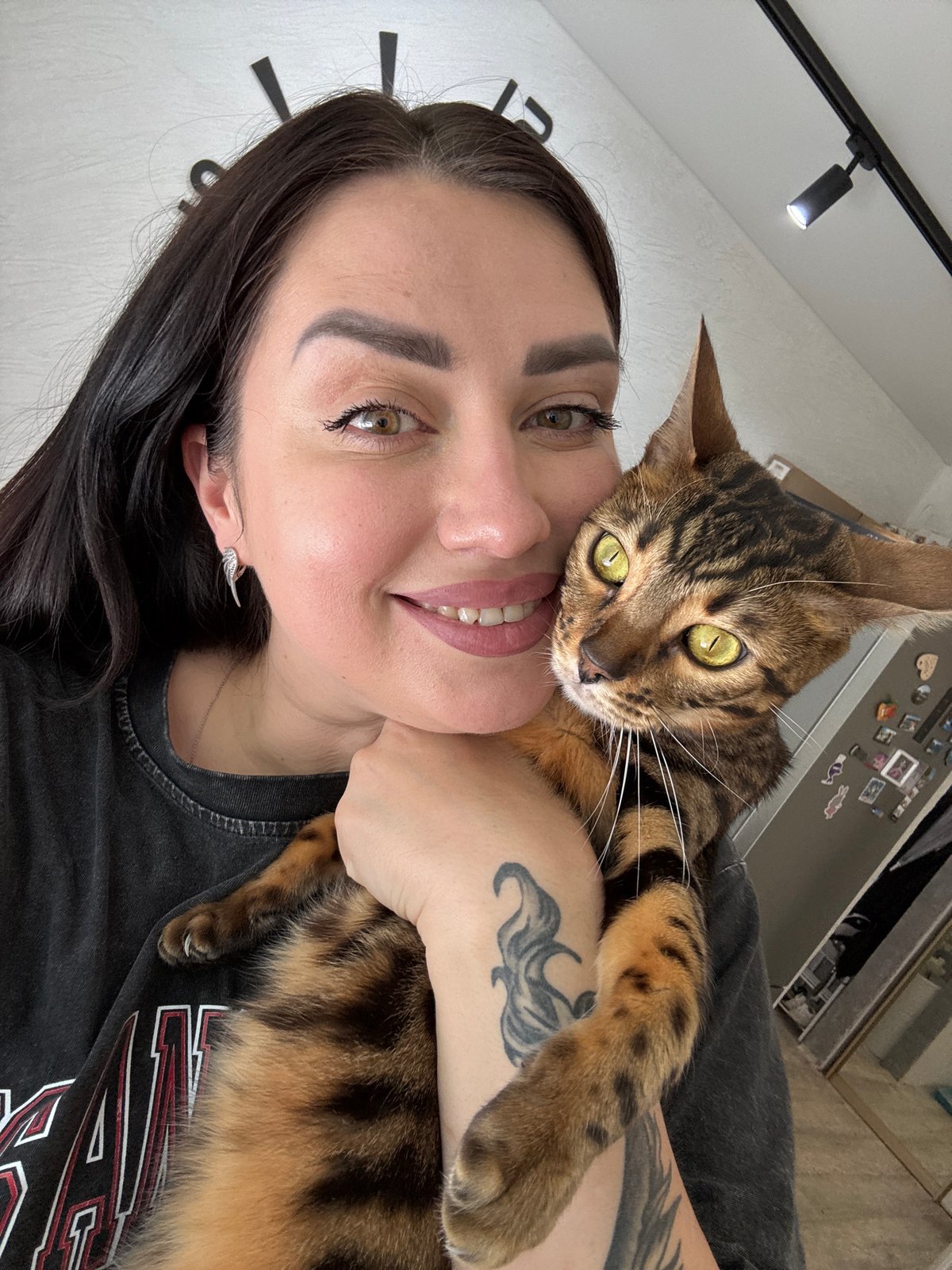 Woman documents morning routine with Bengal and tabby cats
