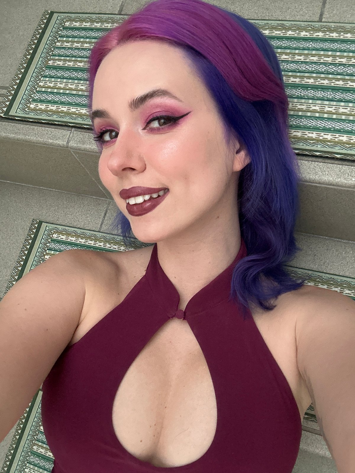 Woman with colorful hair takes selfies in Zagreb home