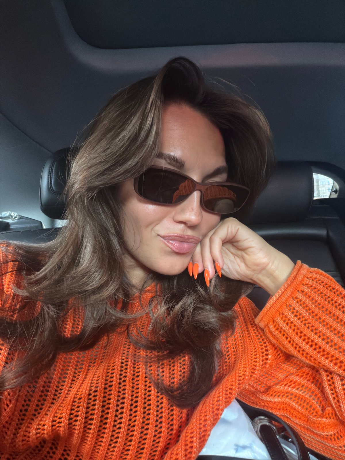 Person photographed posing in vehicle in New York