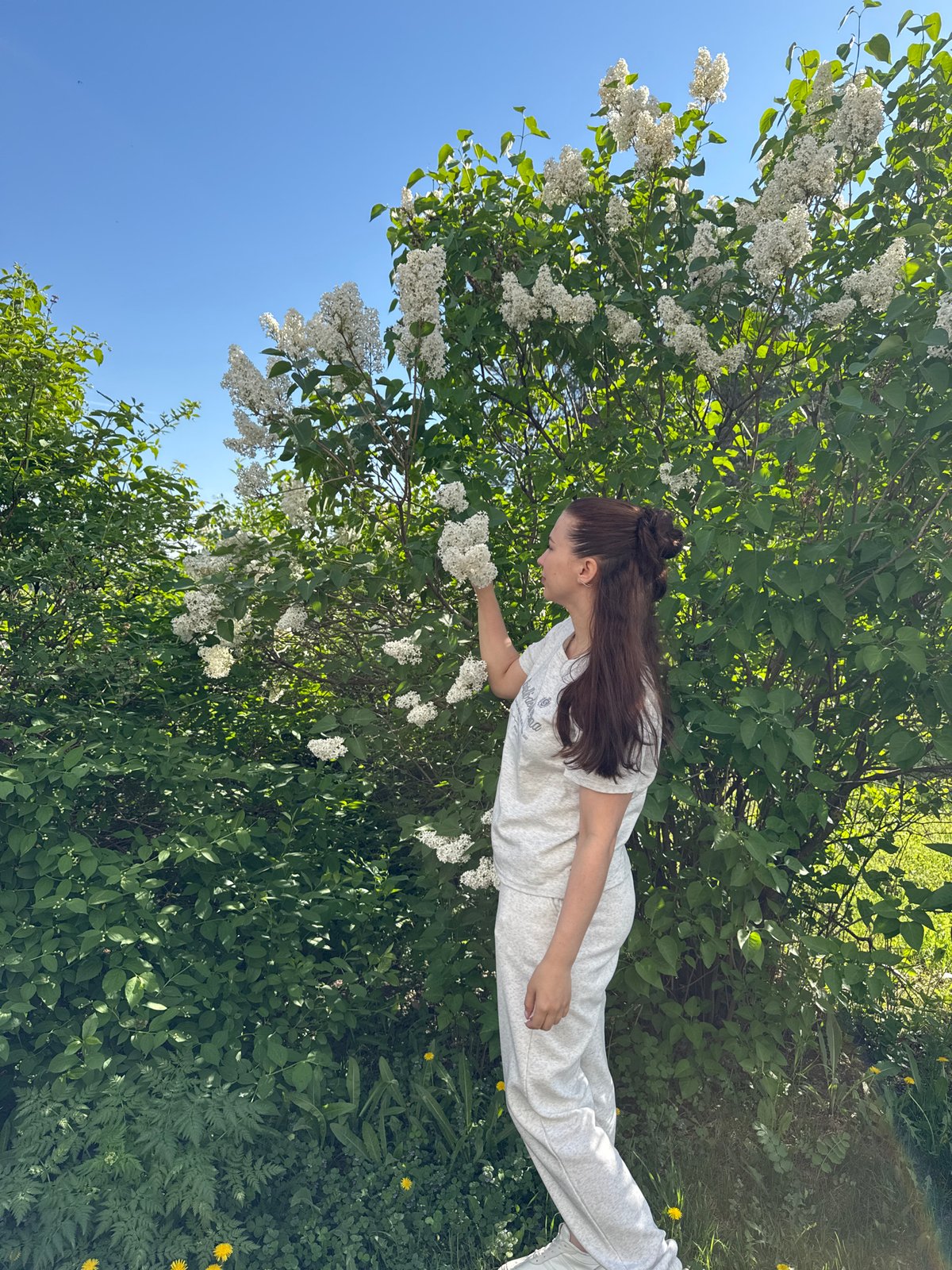 Woman enjoys spring morning with baby in Chaikovsky, Russia