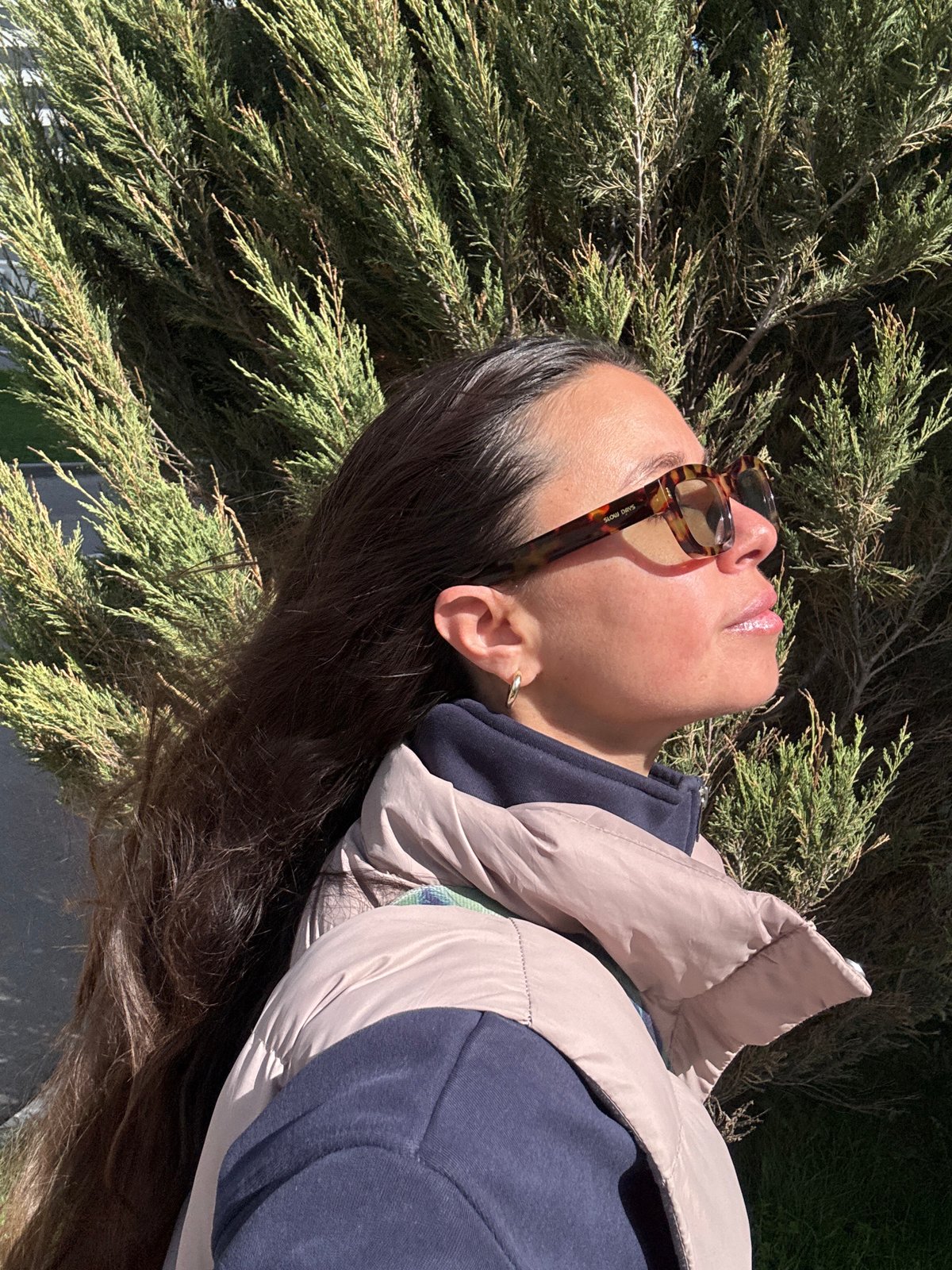 Woman rests in sunlit vegetation in Kazan