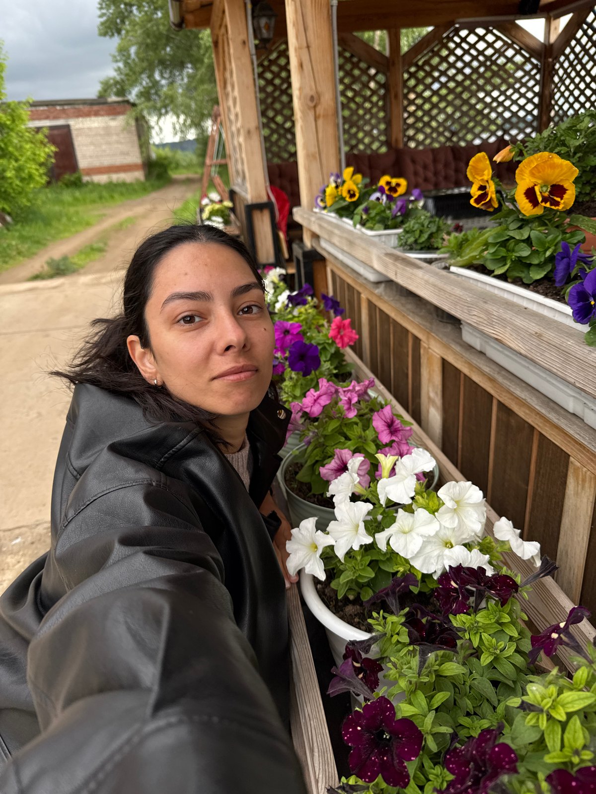 Woman photographs at waterfront gazebo in Chaikovsky, Russia