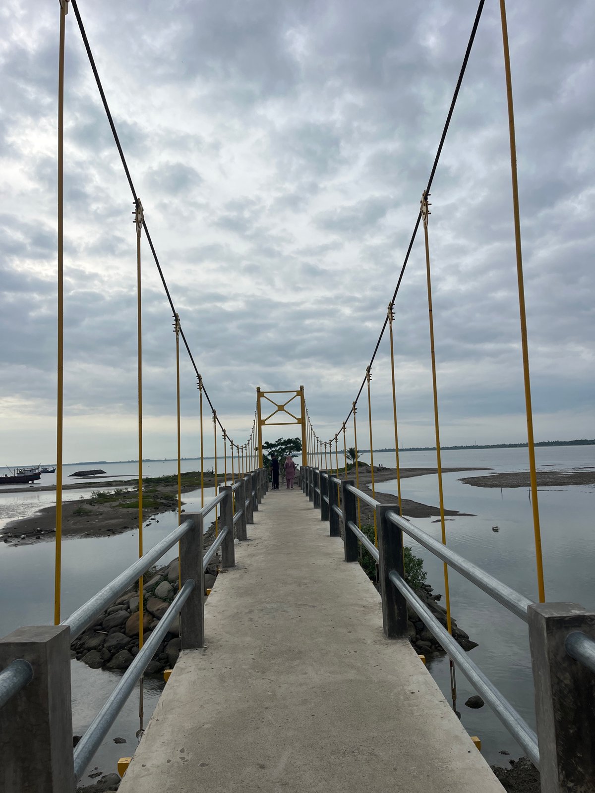 Suspension bridge observed spanning waterway in Lhokseumawe, Indonesia