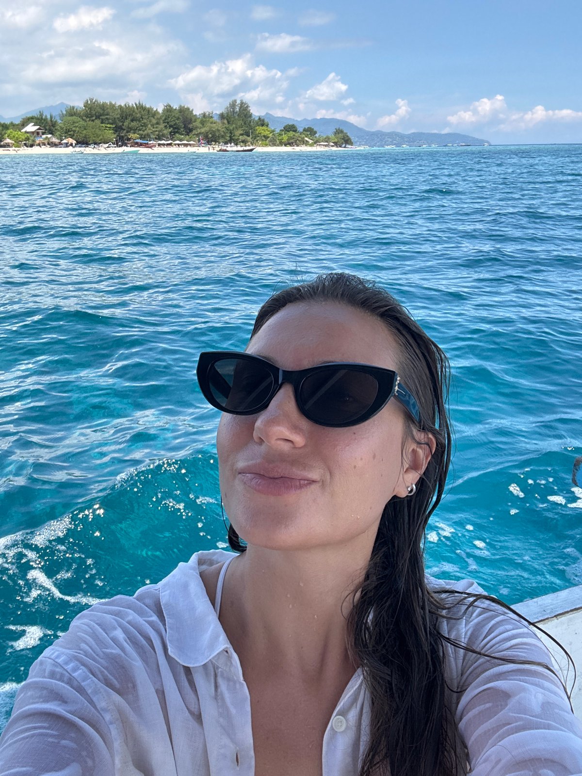 Woman enjoys boat trip in turquoise Indonesian waters