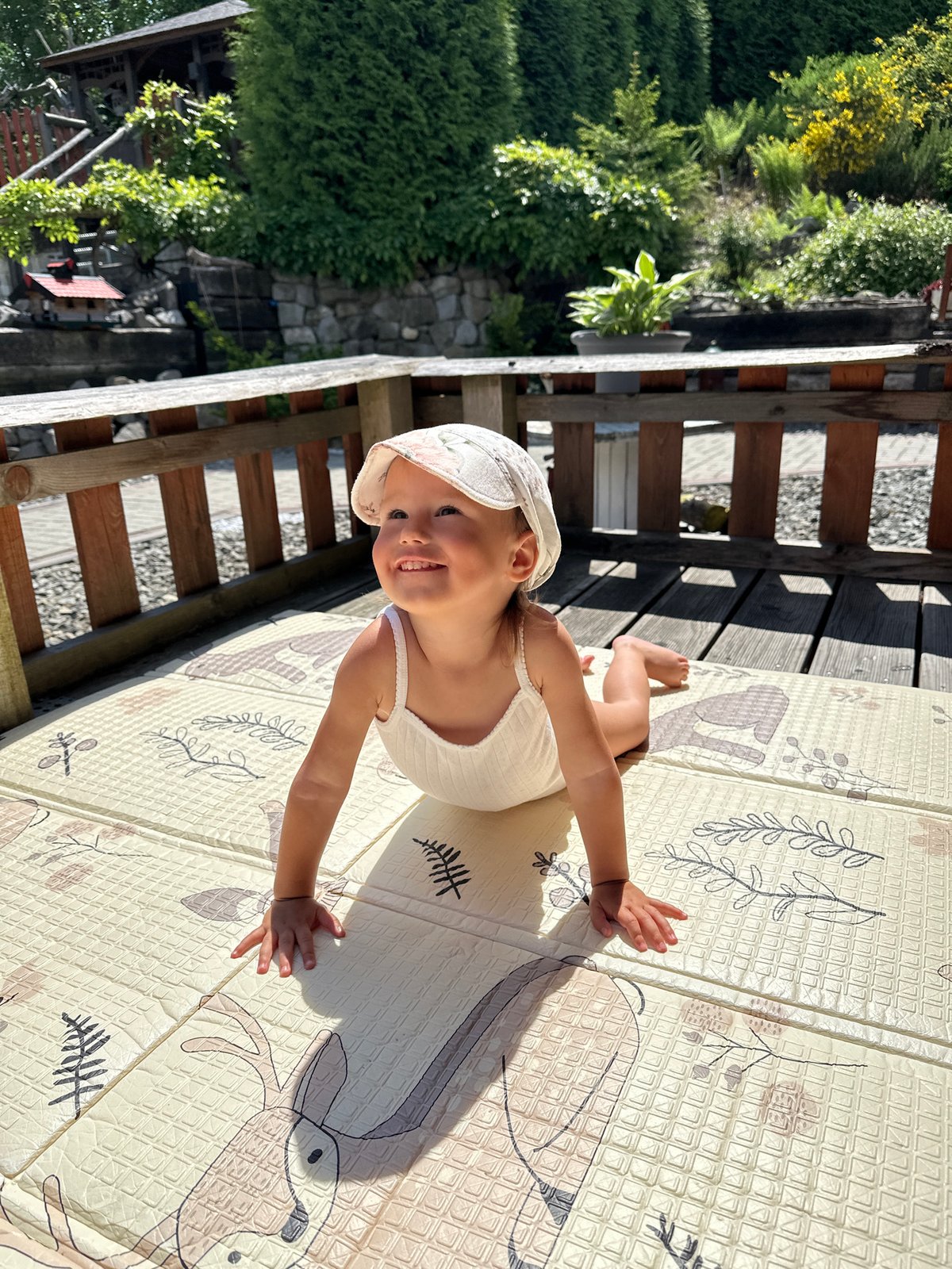 Child plays on outdoor mat in Wisła, Poland