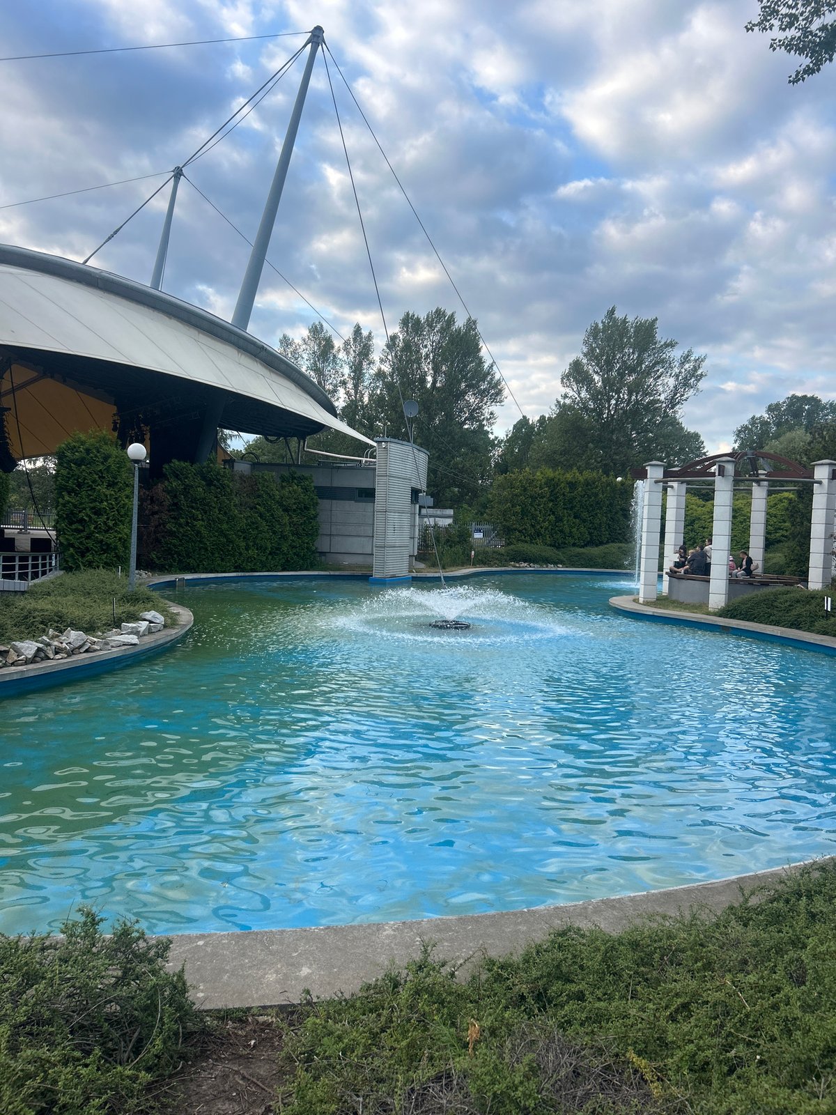 Turquoise fountain pool on a cloudy afternoon in Warsaw