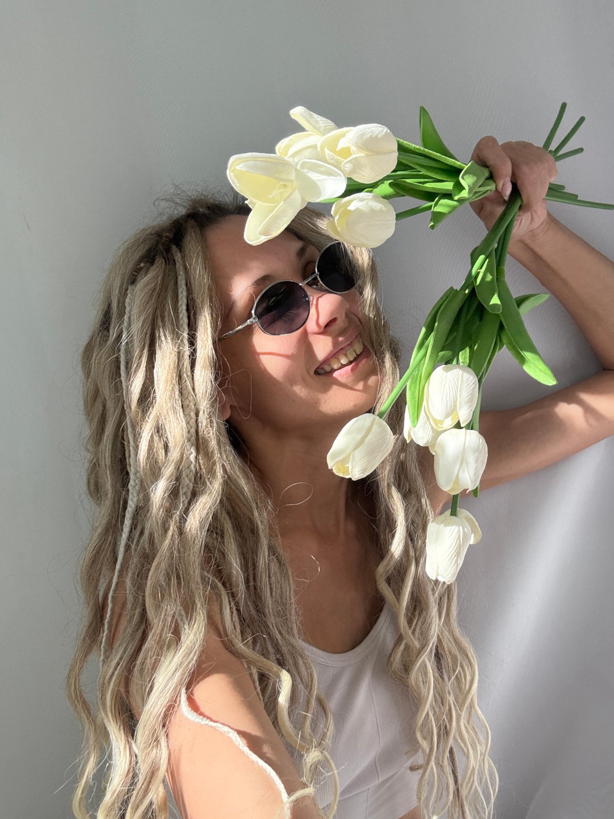 Woman with braided blonde hair photographed lying down