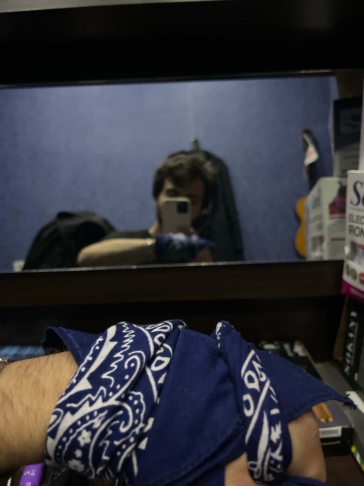 Man takes multiple mirror selfies in Tbilisi room